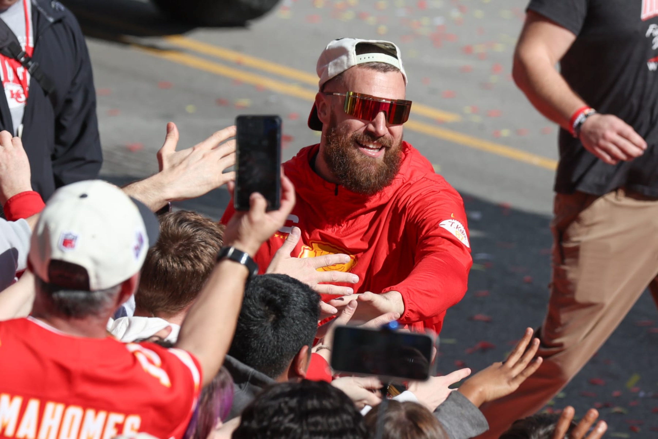 KANSAS CITY, MO - FEBRUARY 14: Travis Kelce smiles and high fives with fans during the Kansas City Chiefs Super Bowl LVIII Victory Parade on Feb 14, 2024 in Kansas City, MO. (Photo by Scott Winters/Icon Sportswire via Getty Images)