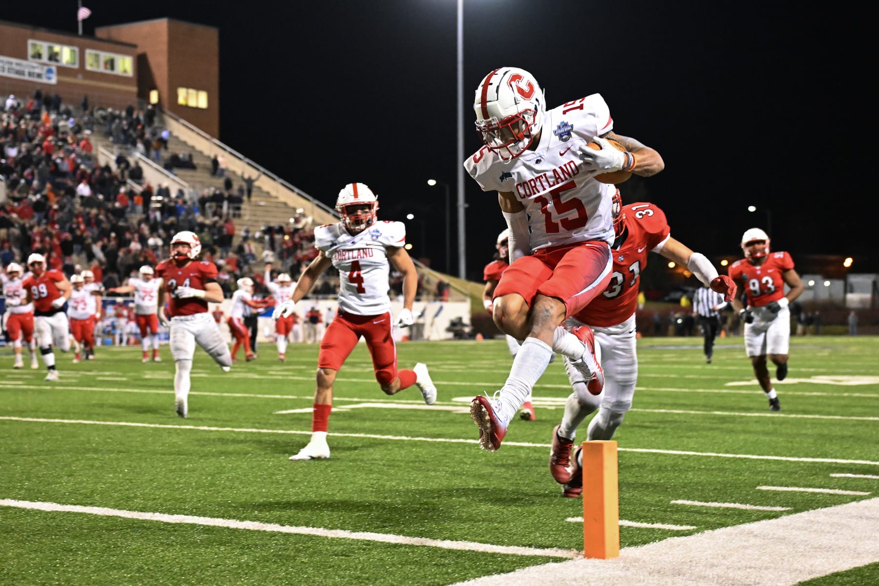 SALEM, VIRGINIA - DECEMBER 15:  Cole Burgess #15 of the Cortland Red Dragons scores the final touchdown against the North Central Cardinals during the Division III Football Championship held at Salem Stadium on December 15, 2023 in Salem, Virginia. Cortland won 38-37. (Photo by Grant Halverson/NCAA Photos via Getty Images)