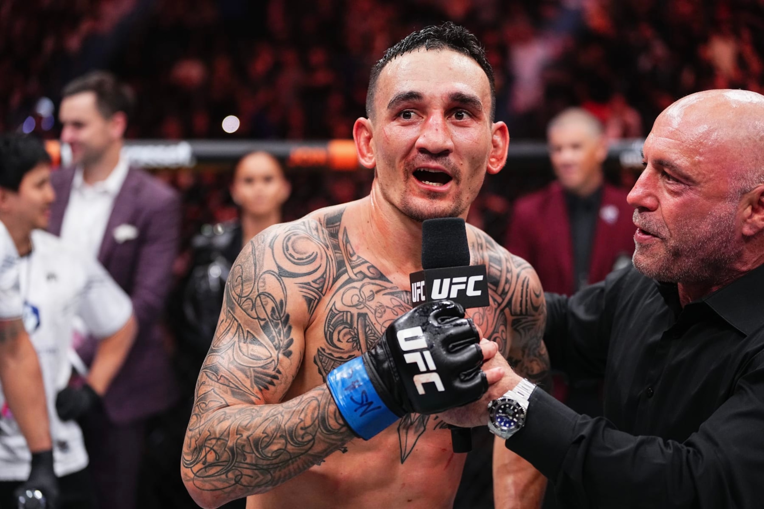 LAS VEGAS, NEVADA - APRIL 13: (R-L) Joe Rogan interviews Max Holloway in the BMF championship fight during the UFC 300 event at T-Mobile Arena on April 13, 2024 in Las Vegas, Nevada. (Photo by Jeff Bottari/Zuffa LLC via Getty Images) LAS VEGAS, NEVADA - APRIL 13: (R-L) Joe Rogan interviews Max Holloway in the BMF championship fight during the UFC 300 event at T-Mobile Arena on April 13, 2024 in Las Vegas, Nevada. (Photo by Jeff Bottari/Zuffa LLC via Getty Images)