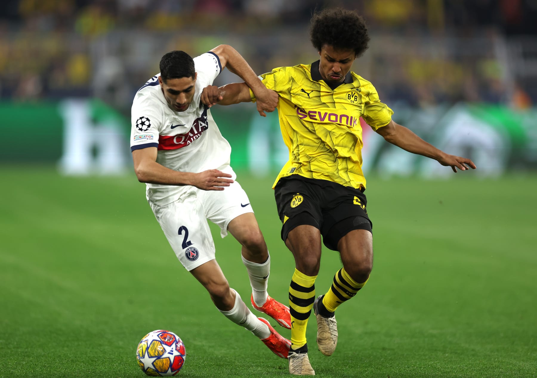 DORTMUND, GERMANY - MAY 01: Achraf Hakimi of Paris Saint-Germain is challenged by Karim Adeyemi of Borussia Dortmund during the UEFA Champions League semi-final first leg match between Borussia Dortmund and Paris Saint-Germain at Signal Iduna Park on May 01, 2024 in Dortmund, Germany. (Photo by Lars Baron/Getty Images) (Photo by Lars Baron/Getty Images)