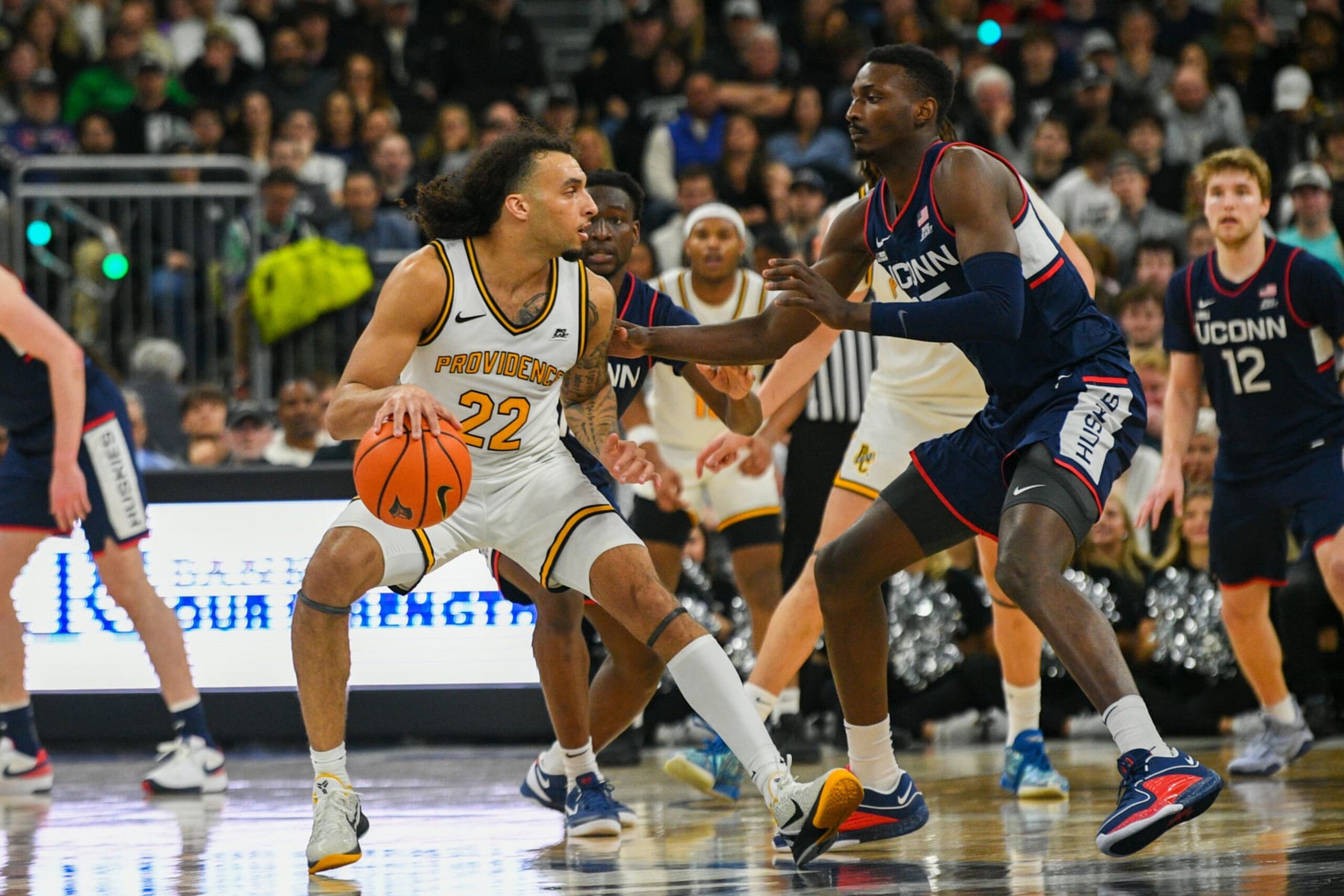 PROVIDENCE, RI - MARCH 09: Providence College Friars guard Devin Carter (22) handles the ball while defended by UConn Huskies forward Samson Johnon (35) during a college basketball game between the UConn Huskies and the Providence College Friars on March 9, 2024 at Amica Mutual Pavilion in Providence, RI. (Photo by Erica Denhoff/Icon Sportswire via Getty Images)