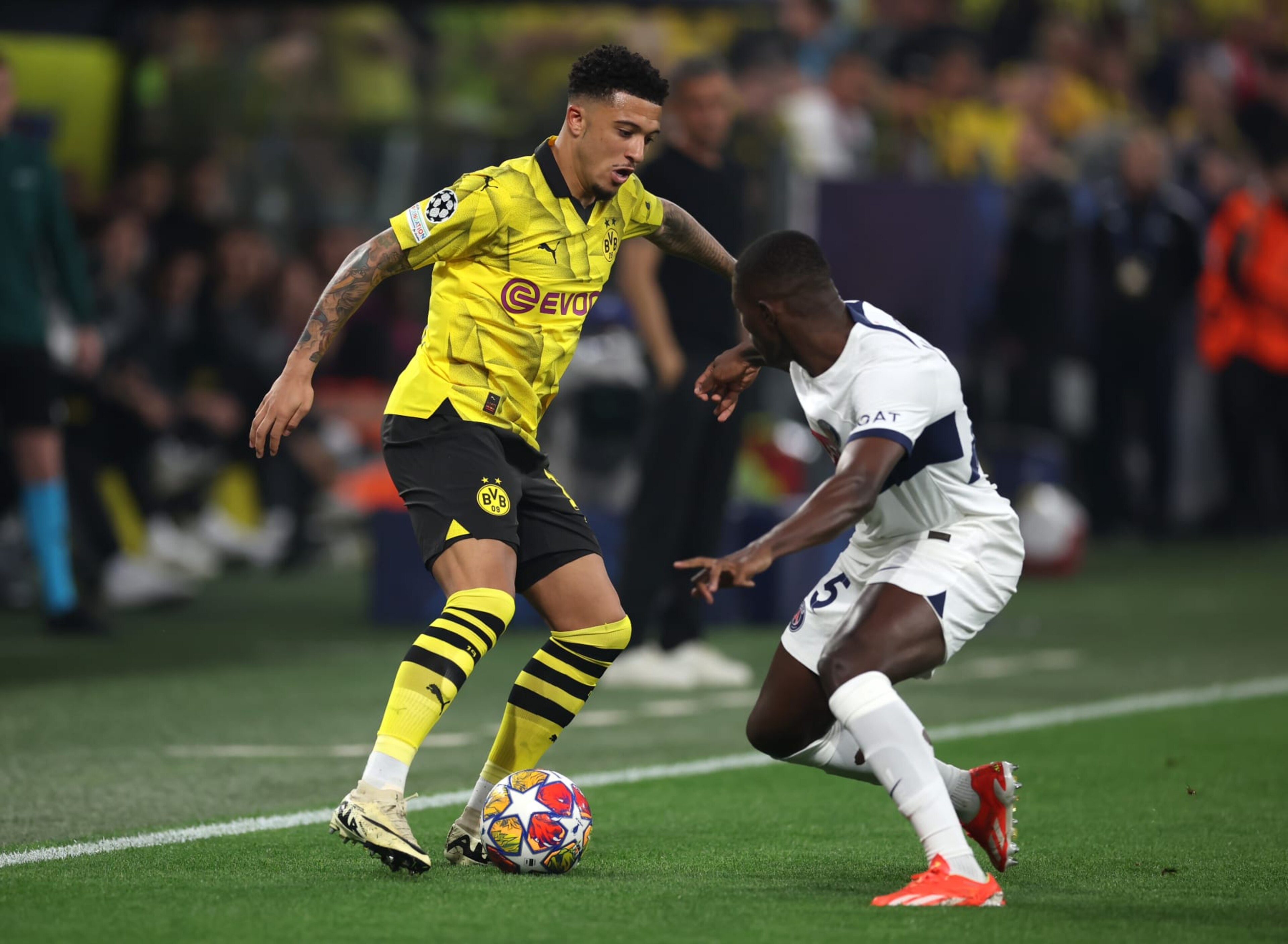 DORTMUND, GERMANY - MAY 01: Jadon Sancho of Borussia Dortmund on the ball whilst under pressure from Nuno Mendes of Paris Saint-Germain during the UEFA Champions League semi-final first leg match between Borussia Dortmund and Paris Saint-Germain at Signal Iduna Park on May 01, 2024 in Dortmund, Germany. (Photo by Alex Grimm/Getty Images) (Photo by Alex Grimm/Getty Images) DORTMUND, GERMANY - MAY 01: Jadon Sancho of Borussia Dortmund on the ball whilst under pressure from Nuno Mendes of Paris Saint-Germain during the UEFA Champions League semi-final first leg match between Borussia Dortmund and Paris Saint-Germain at Signal Iduna Park on May 01, 2024 in Dortmund, Germany. (Photo by Alex Grimm/Getty Images) (Photo by Alex Grimm/Getty Images)