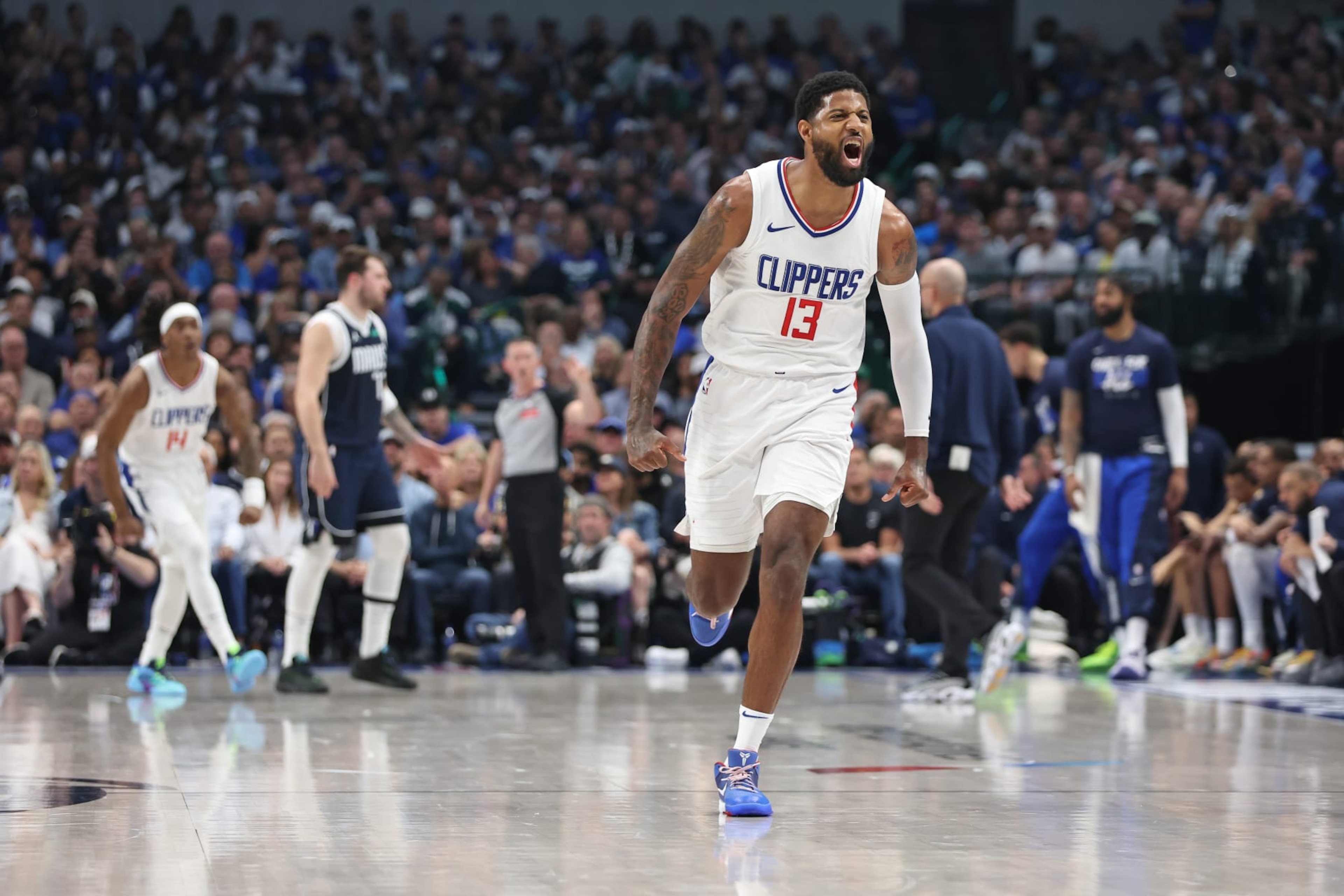 DALLAS, TX - APRIL 28: Paul George #13 of the LA Clippers celebrates during the game against the Dallas Mavericks during Round 1 Game 4 of the 2024 NBA Playoffs on April 28, 2024 at the American Airlines Center in Dallas, Texas. NOTE TO USER: User expressly acknowledges and agrees that, by downloading and or using this photograph, User is consenting to the terms and conditions of the Getty Images License Agreement. Mandatory Copyright Notice: Copyright 2024 NBAE (Photo by Tim Heitman/NBAE via Getty Images)