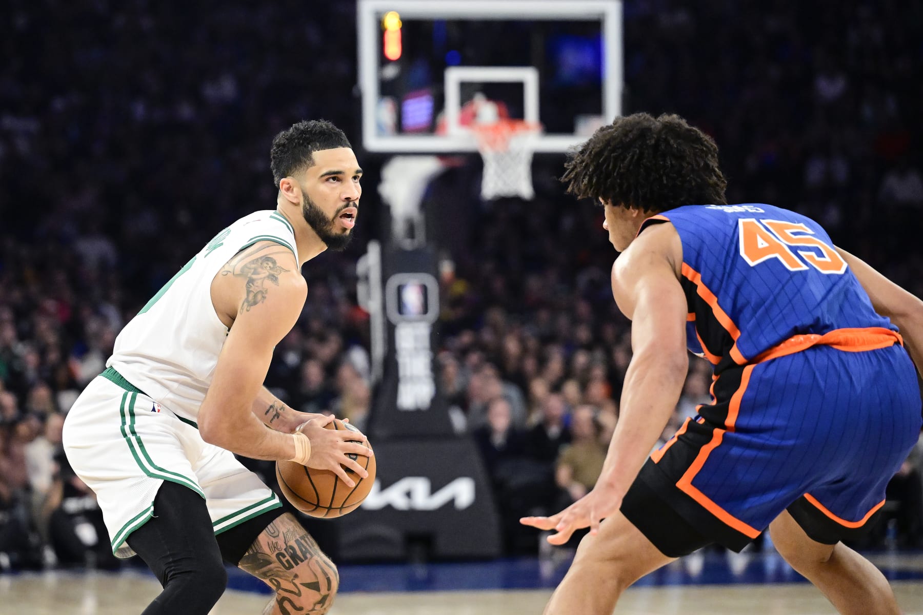 NEW YORK, NEW YORK - FEBRUARY 24:  Jayson Tatum #0 of the Boston Celtics is defended by Jericho Sims #45 of the New York Knicks during the game at Madison Square Garden on February 24, 2024 in New York City. NOTE TO USER: User expressly acknowledges and agrees that, by downloading and or using this photograph, User is consenting to the terms and conditions of the Getty Images License Agreement. (Photo by Steven Ryan/Getty Images)