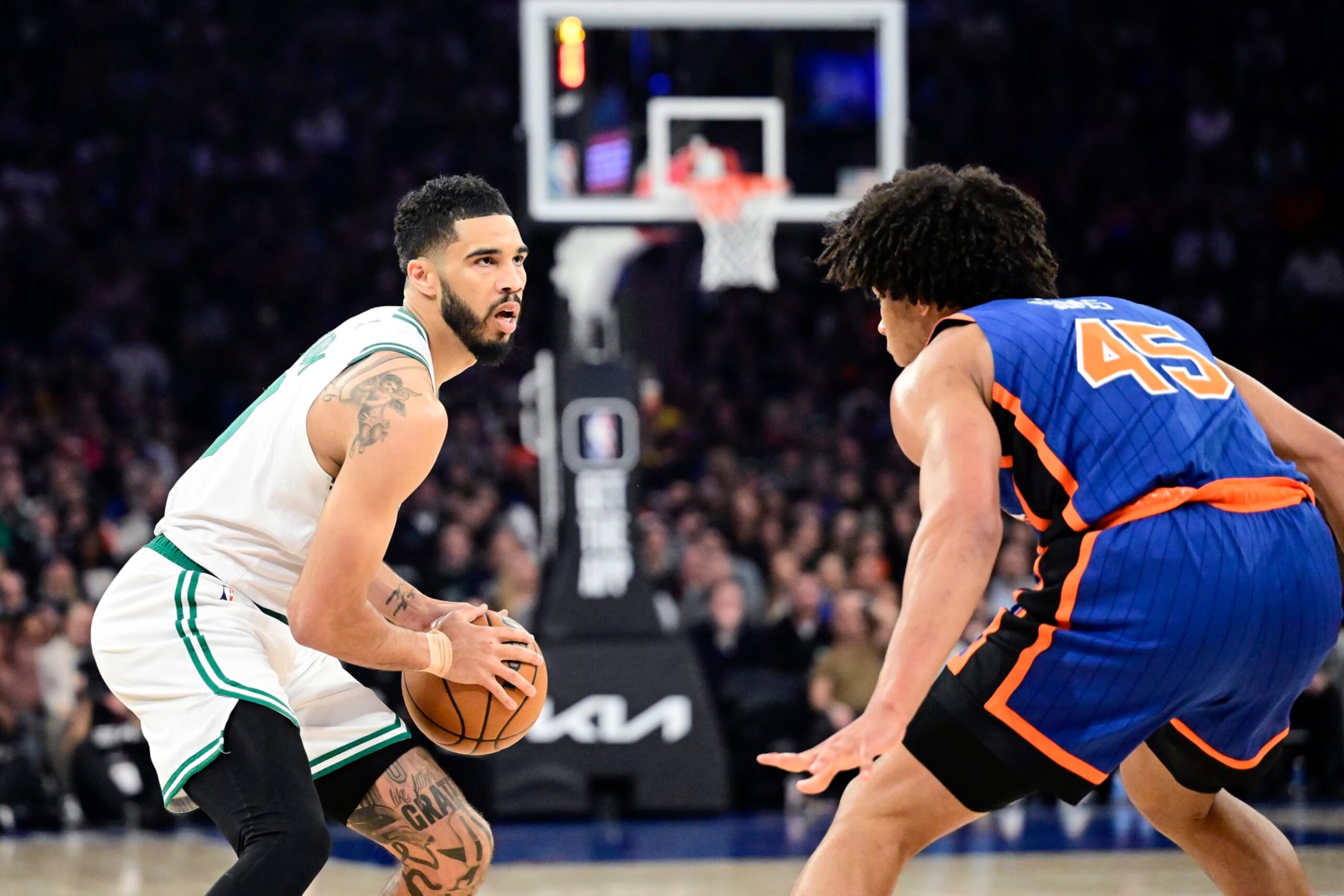 NEW YORK, NEW YORK - FEBRUARY 24:  Jayson Tatum #0 of the Boston Celtics is defended by Jericho Sims #45 of the New York Knicks during the game at Madison Square Garden on February 24, 2024 in New York City. NOTE TO USER: User expressly acknowledges and agrees that, by downloading and or using this photograph, User is consenting to the terms and conditions of the Getty Images License Agreement. (Photo by Steven Ryan/Getty Images)