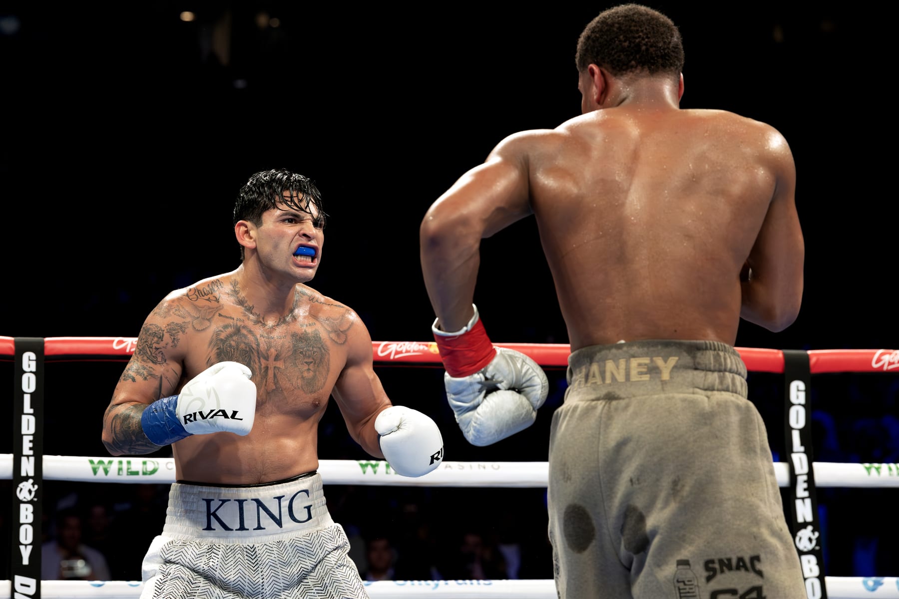 NEW YORK, NEW YORK - APRIL 20:   Ryan Garcia (white trunks) reacts against Devin Haney (gray trunks) during their WBC Super Lightweight title bout at Barclays Center on April 20, 2024 in New York City.  (Photo by Al Bello/Getty Images)