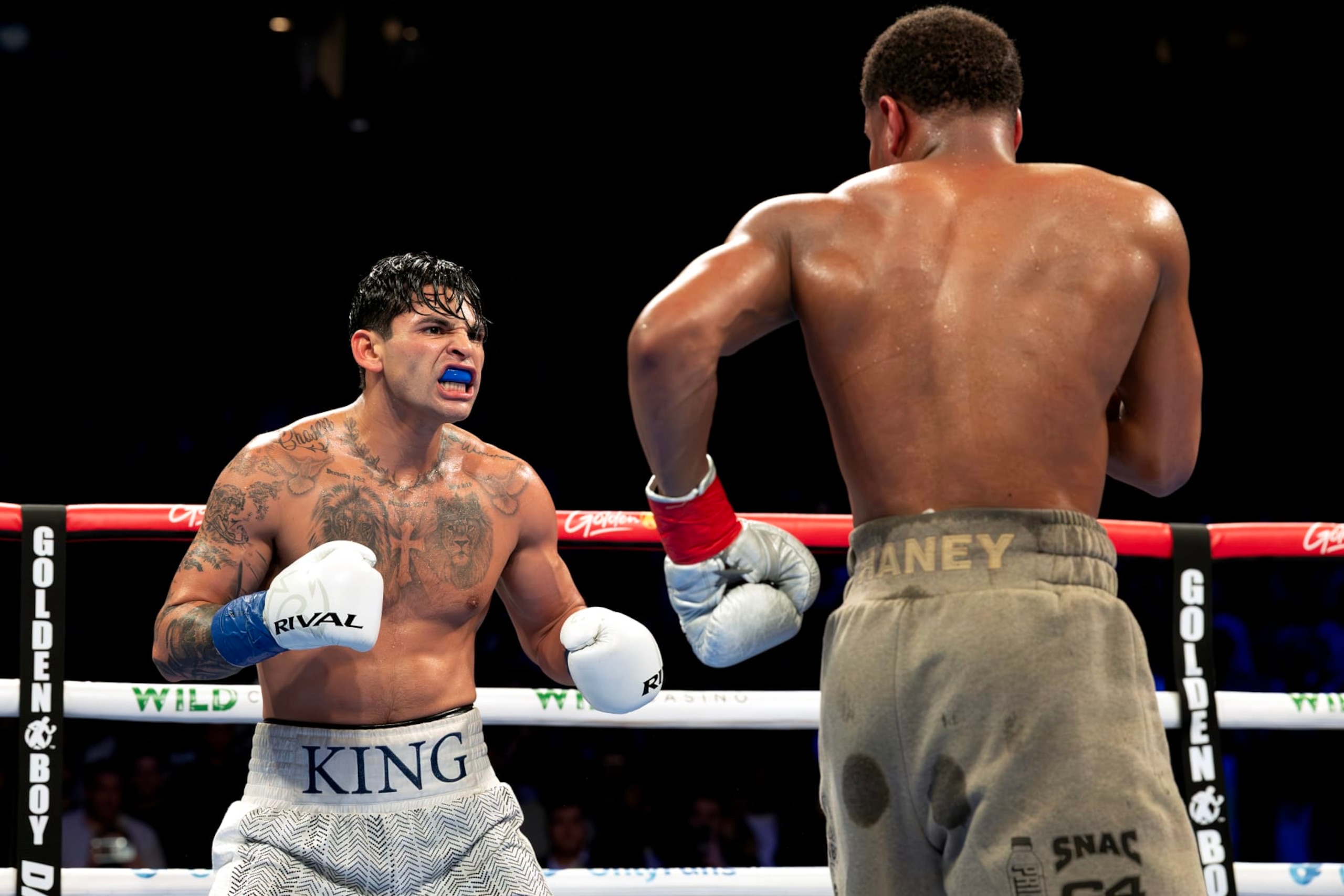 NEW YORK, NEW YORK - APRIL 20:   Ryan Garcia (white trunks) reacts against Devin Haney (gray trunks) during their WBC Super Lightweight title bout at Barclays Center on April 20, 2024 in New York City.  (Photo by Al Bello/Getty Images)