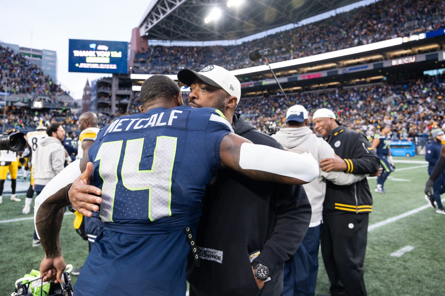 SEATTLE, WASHINGTON - DECEMBER 31: DK Metcalf #14 of the Seattle Seahawks and head coach Mike Tomlin of the Pittsburgh Steelers embrace after the game at Lumen Field on December 31, 2023 in Seattle, Washington. (Photo by Conor Courtney/Getty Images) SEATTLE, WASHINGTON - DECEMBER 31: DK Metcalf #14 of the Seattle Seahawks and head coach Mike Tomlin of the Pittsburgh Steelers embrace after the game at Lumen Field on December 31, 2023 in Seattle, Washington. (Photo by Conor Courtney/Getty Images)
