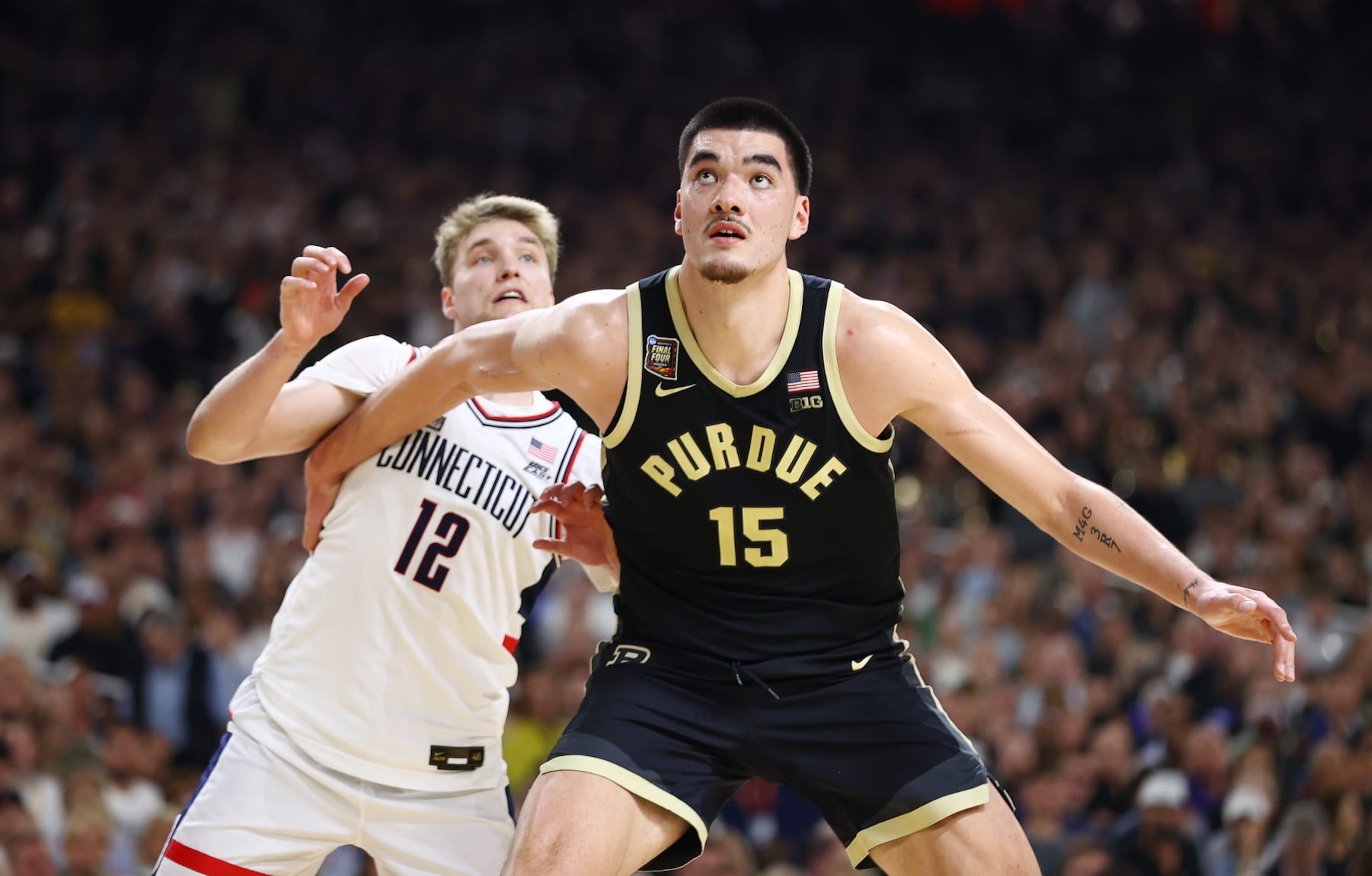 GLENDALE, ARIZONA - APRIL 08: Zach Edey #15 of the Purdue Boilermakers boxes out Cam Spencer #12 of the Connecticut Huskies during the second half in the NCAA Men's Basketball Tournament National Championship game at State Farm Stadium on April 08, 2024 in Glendale, Arizona. (Photo by Jamie Schwaberow/NCAA Photos via Getty Images) GLENDALE, ARIZONA - APRIL 08: Zach Edey #15 of the Purdue Boilermakers boxes out Cam Spencer #12 of the Connecticut Huskies during the second half in the NCAA Men's Basketball Tournament National Championship game at State Farm Stadium on April 08, 2024 in Glendale, Arizona. (Photo by Jamie Schwaberow/NCAA Photos via Getty Images)