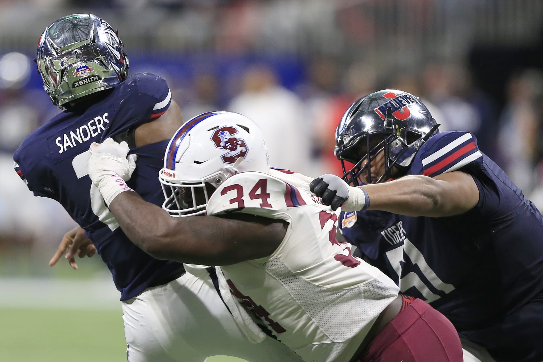 ATLANTA, GA - DECEMBER 18:  Linebacker Jeblonski Green #34 of the South Carolina State Bulldogs tackles  quarterback Shedeur Sanders #2 of the Jackson State Tigers during the college football Cricket Celebration Bowl game between the South Carolina State Bulldogs and the Jackson State Tigers on December 18, 2021 at the Mercedes-Benz Stadium in Atlanta, Georgia.   (Photo by David J. Griffin/Icon Sportswire via Getty Images)