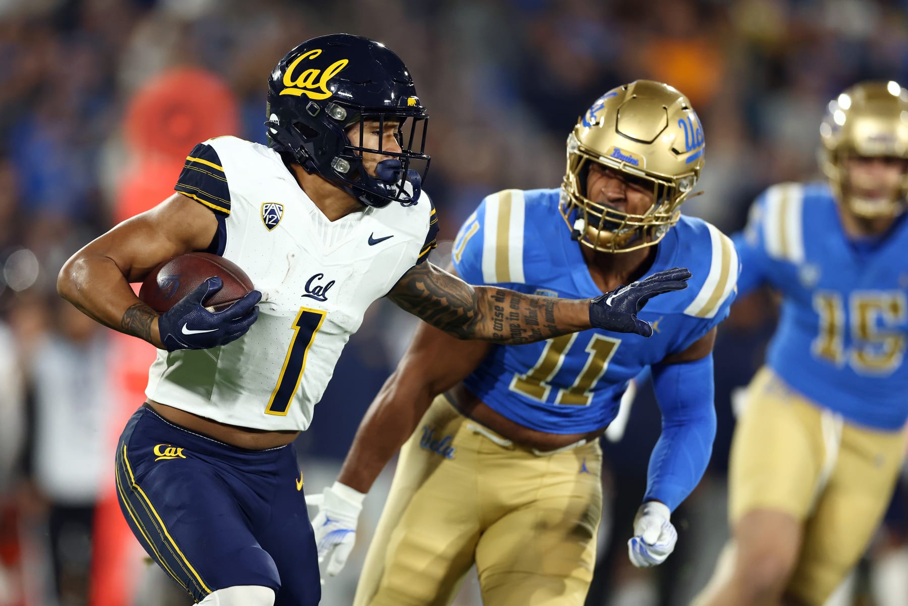 PASADENA, CALIFORNIA - NOVEMBER 25: Jaydn Ott #1 of the California Golden Bears runs the ball against Gabriel Murphy #11 of the UCLA Bruins during the first quarter at Rose Bowl Stadium on November 25, 2023 in Pasadena, California. (Photo by Katelyn Mulcahy/Getty Images)