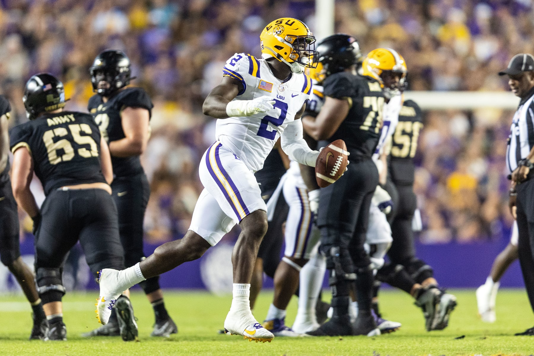BATON ROUGE, LA - OCTOBER 21: LSU Tigers defensive end Ovie Oghoufo (2) recovers a fumble during a game between the LSU Tigers and the Army Black Knights on October 21, 2023, at Tiger Stadium in Baton Rouge, Louisiana. (Photo by John Korduner/Icon Sportswire via Getty Images)