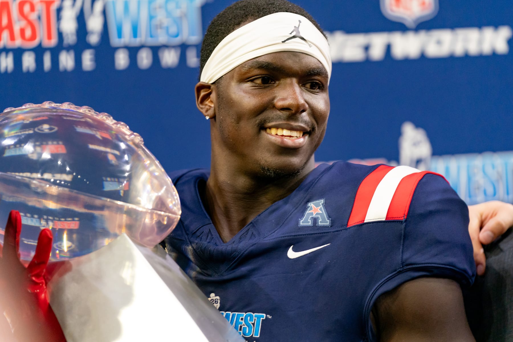 FRISCO, TX - FEBRUARY 01: West Team cornerback Jarius Monroe (32) of Tulane smiles with the championship trophy during the East-West Shrine Bowl game on February 1, 2024 at the Ford Center at the star in Frisco, TX. (Photo by Chris Leduc/Icon Sportswire via Getty Images)