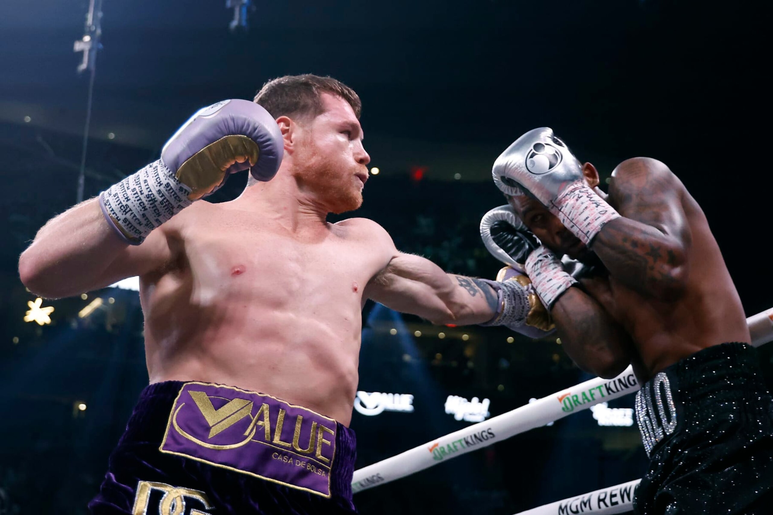 LAS VEGAS, NEVADA - SEPTEMBER 30: Saul "Canelo" Alvarez of Mexico (purple/gold trunks) trades punches with Jermell Charlo (black trunks) during their super middleweight title fight at T-Mobile Arena on September 30, 2023 in Las Vegas, Nevada. (Photo by Sarah Stier/Getty Images) LAS VEGAS, NEVADA - SEPTEMBER 30: Saul "Canelo" Alvarez of Mexico (purple/gold trunks) trades punches with Jermell Charlo (black trunks) during their super middleweight title fight at T-Mobile Arena on September 30, 2023 in Las Vegas, Nevada. (Photo by Sarah Stier/Getty Images)