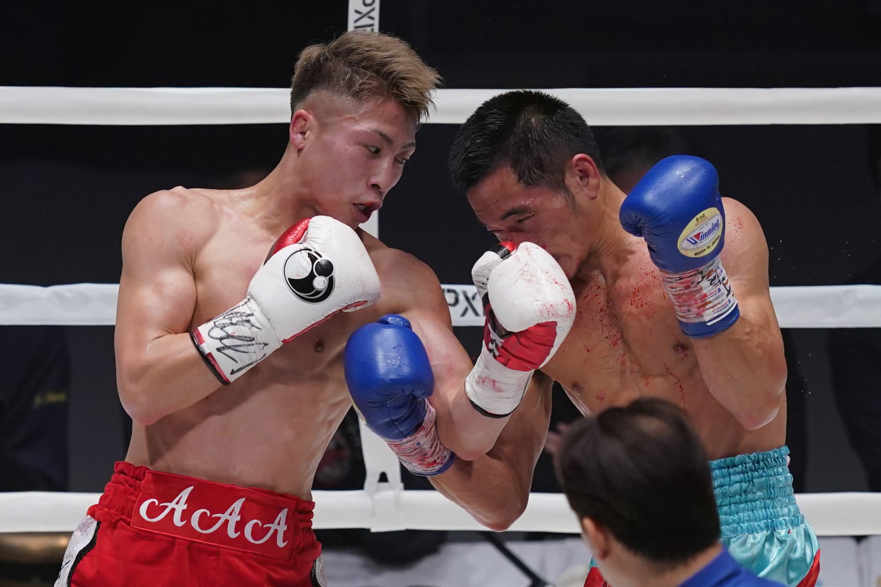 TOKYO, JAPAN - DECEMBER 14: Naoya Inoue (L) of Japan punches Aran Dipaen of Thailand during the WBA Super Bantamweight and IBO Bantamweight title bout at Ryogoku Kokugikan on December 14, 2021 in Tokyo, Japan. (Photo by Toru Hanai/Getty Images)