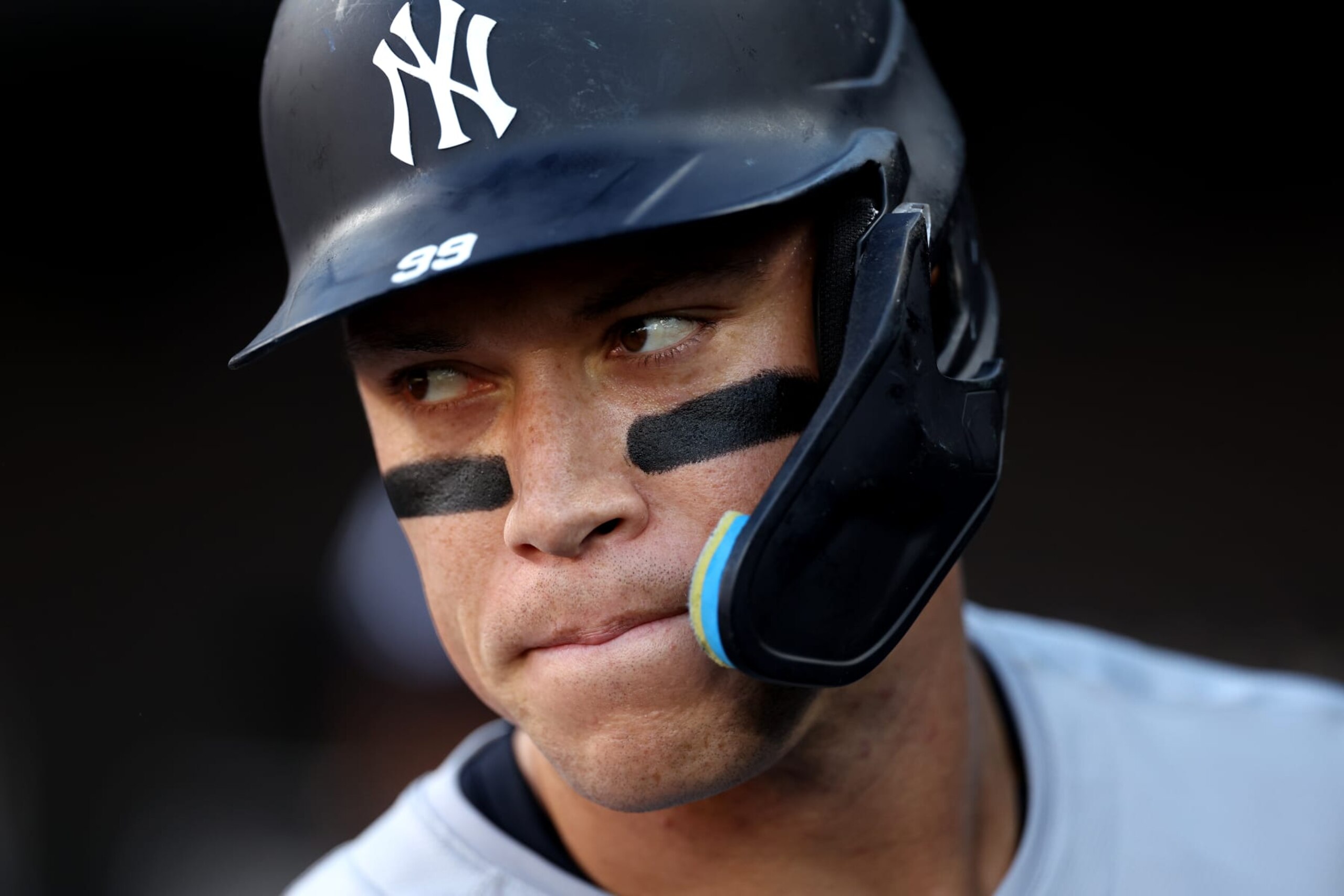 BALTIMORE, MARYLAND - MAY 01: Aaron Judge #99 of the New York Yankees looks on in the dugout before the first inning against the Baltimore Orioles at Oriole Park at Camden Yards on May 1, 2024 in Baltimore, Maryland. (Photo by Patrick Smith/Getty Images)