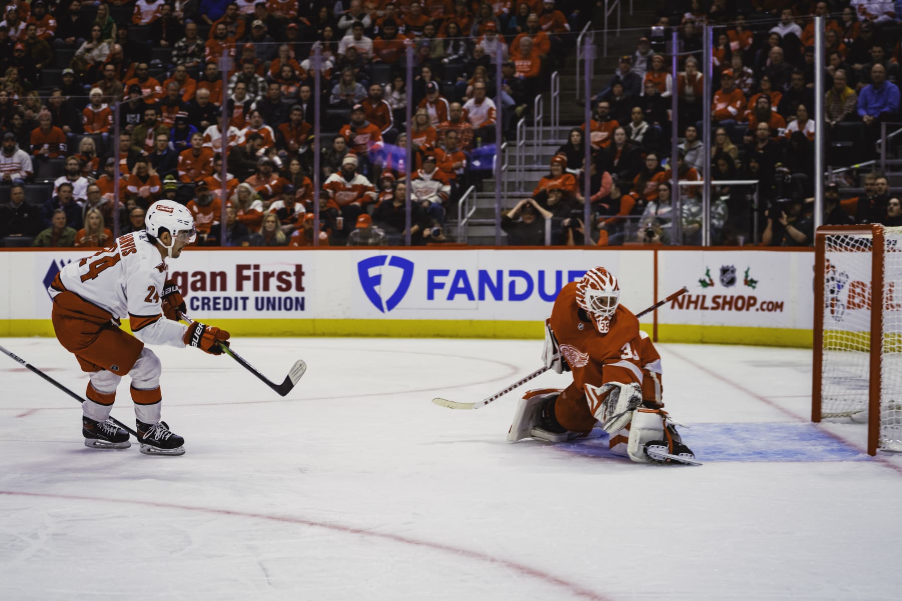 DETROIT, MI - DECEMBER 14: Seth Jarvis #24 of the Carolina Hurricanes shoots the puck wide of the net as goalie Ville Husso #35 of the Detroit Red Wings defends during the second period at Little Caesars Arena on December 14, 2023 in Detroit, Michigan. (Photo by Darren Clark/NHLI via Getty Images)