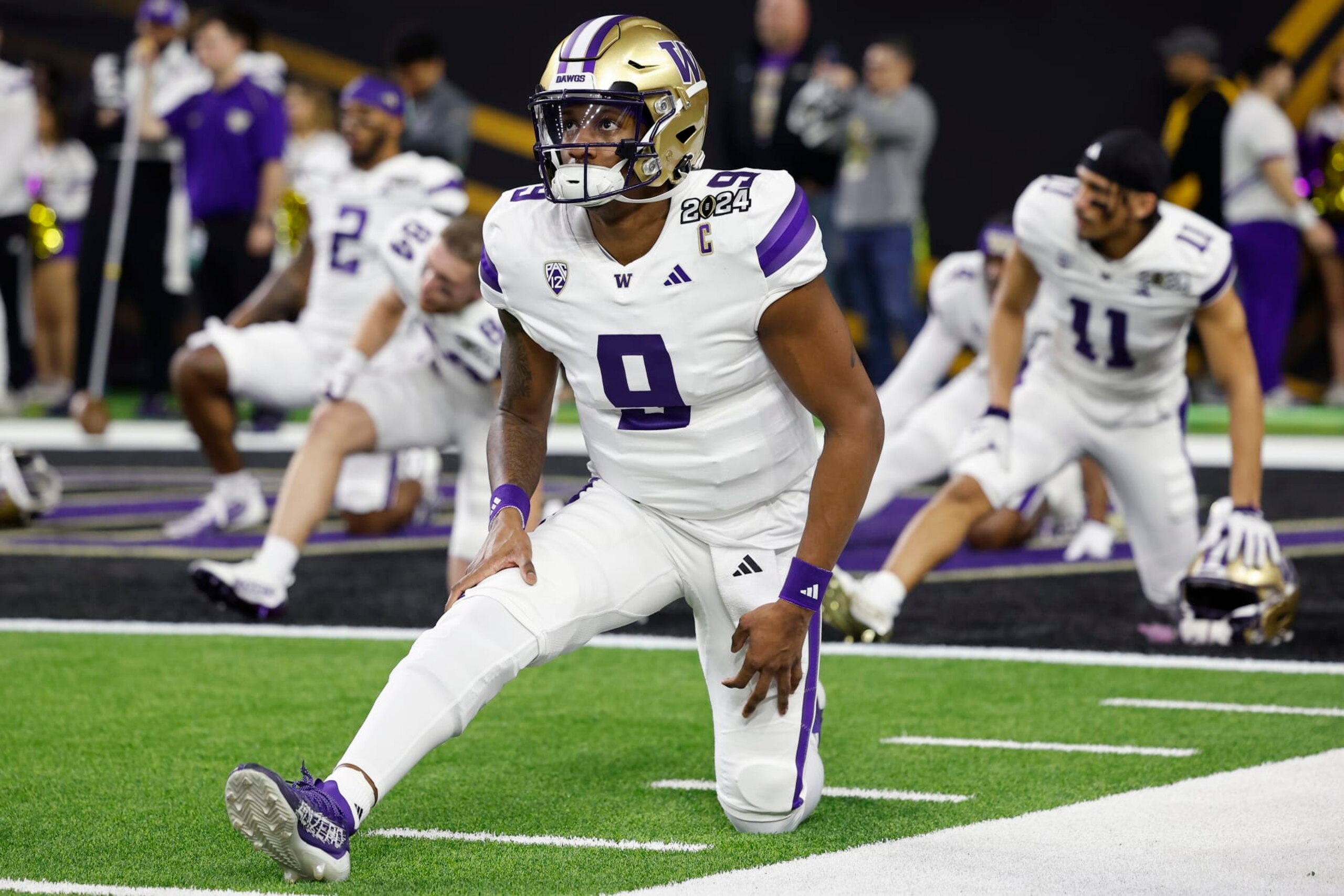 HOUSTON, TX - JANUARY 08: Washington Huskies quarterback Michael Penix Jr. (9) stretches before the CFP National Championship against the Washington Huskies on January 08, 2024 at NRG Stadium in Houston, Texas. (Photo by Joe Robbins/Icon Sportswire via Getty Images)