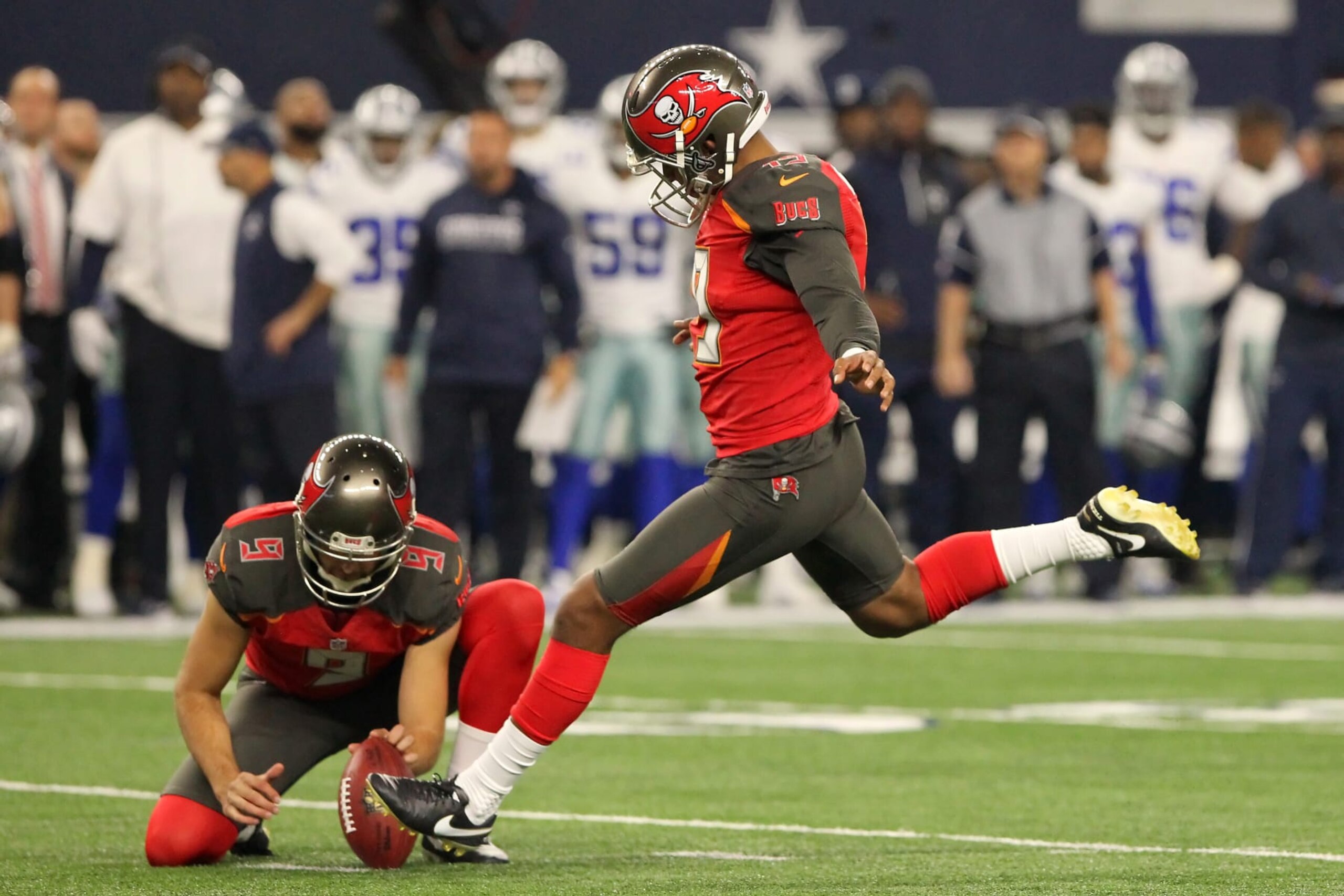 ARLINGTON, TX - DECEMBER 18: Roberto Aguayo (19) of the Buccaneers kicks a field goal from the hold of Bryan Anger (9) during the game between the Dallas Cowboys and the Tampa Bay Buccaneers on December 18, 2016 at AT&T Stadium in Arlington, Texas. Dallas beats Tampa Bay 26-20. (Photo by Cliff Welch/Icon Sportswire via Getty Images)