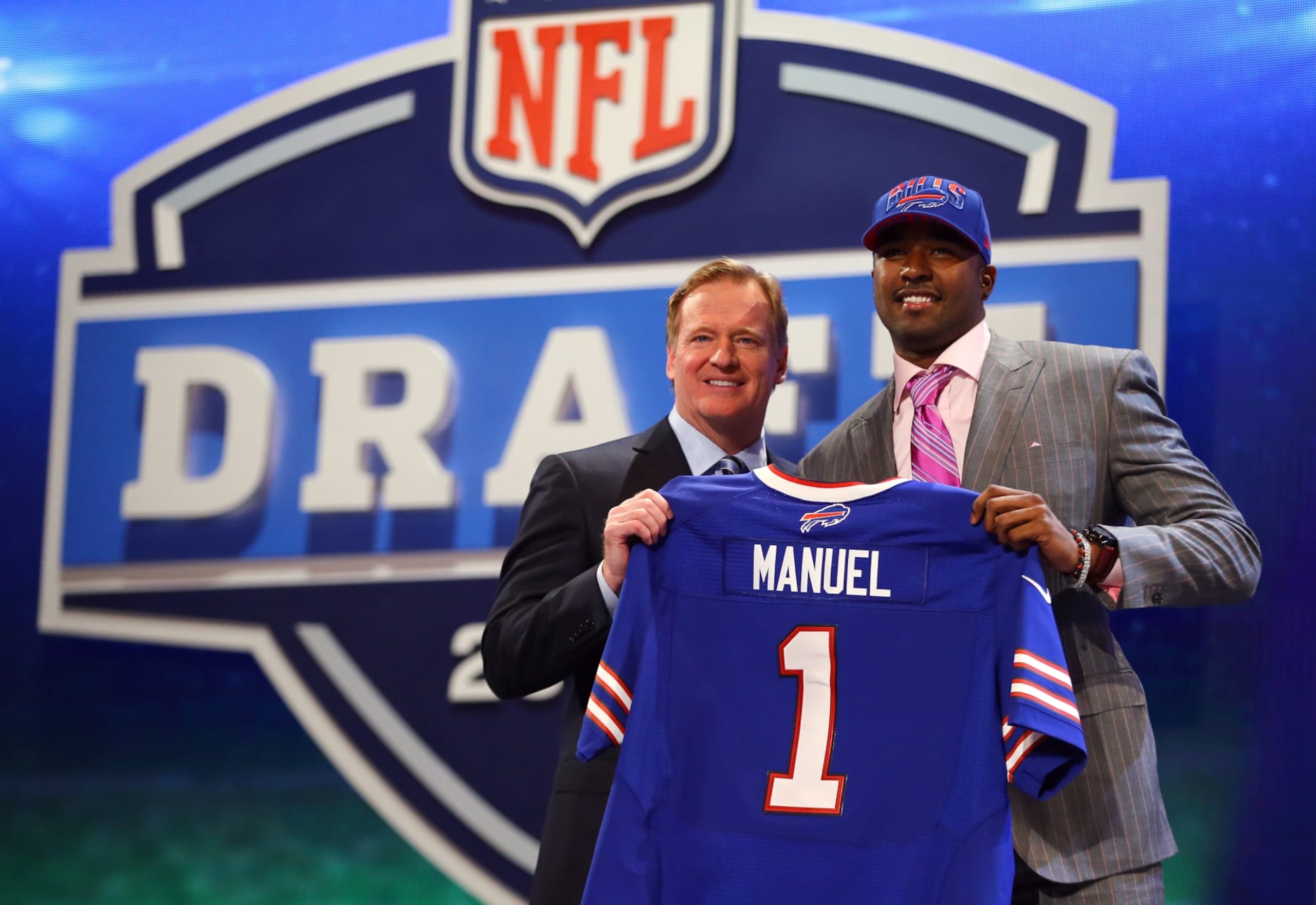 NEW YORK, NY - APRIL 25:  E.J. Manuel of the Florida State Seminoles stands with NFL Commissioner Roger Goodell (L) as they hold up a jersey on stage after Manuel was picked #16 overall by the Buffalo Bills in the first round of the 2013 NFL Draft at Radio City Music Hall on April 25, 2013 in New York City.  (Photo by Al Bello/Getty Images)