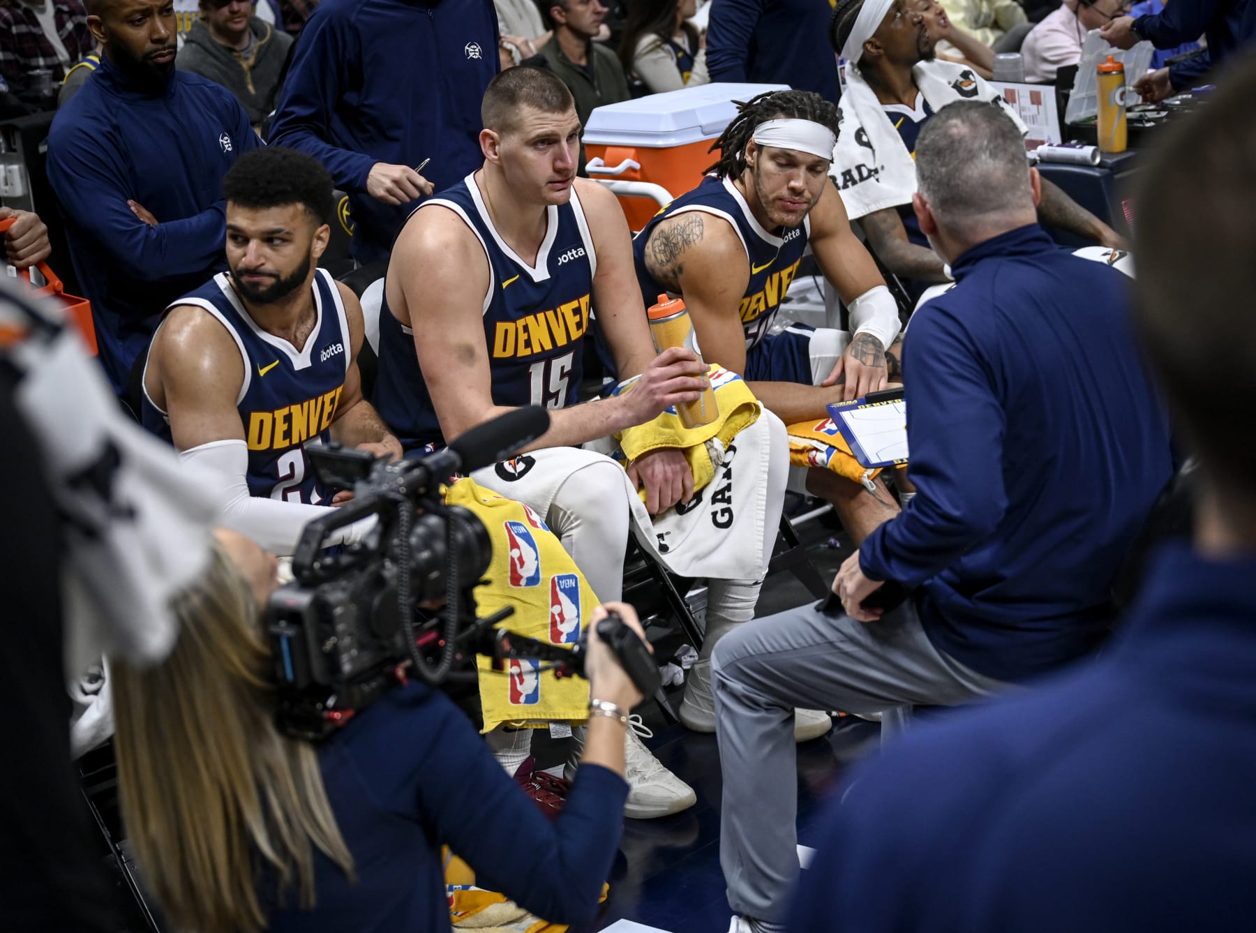 DENVER, CO - JANUARY 14: Jamal Murray (27), Nikola Jokic (15), Aaron Gordon (50) and Kentavious Caldwell-Pope (5) of the Denver Nuggets sit on the bench for a timeout as head coach Michael Malone speaks during the second quarter at Ball Arena in Denver on Sunday, January 14, 2024. (Photo by AAron Ontiveroz/The Denver Post)