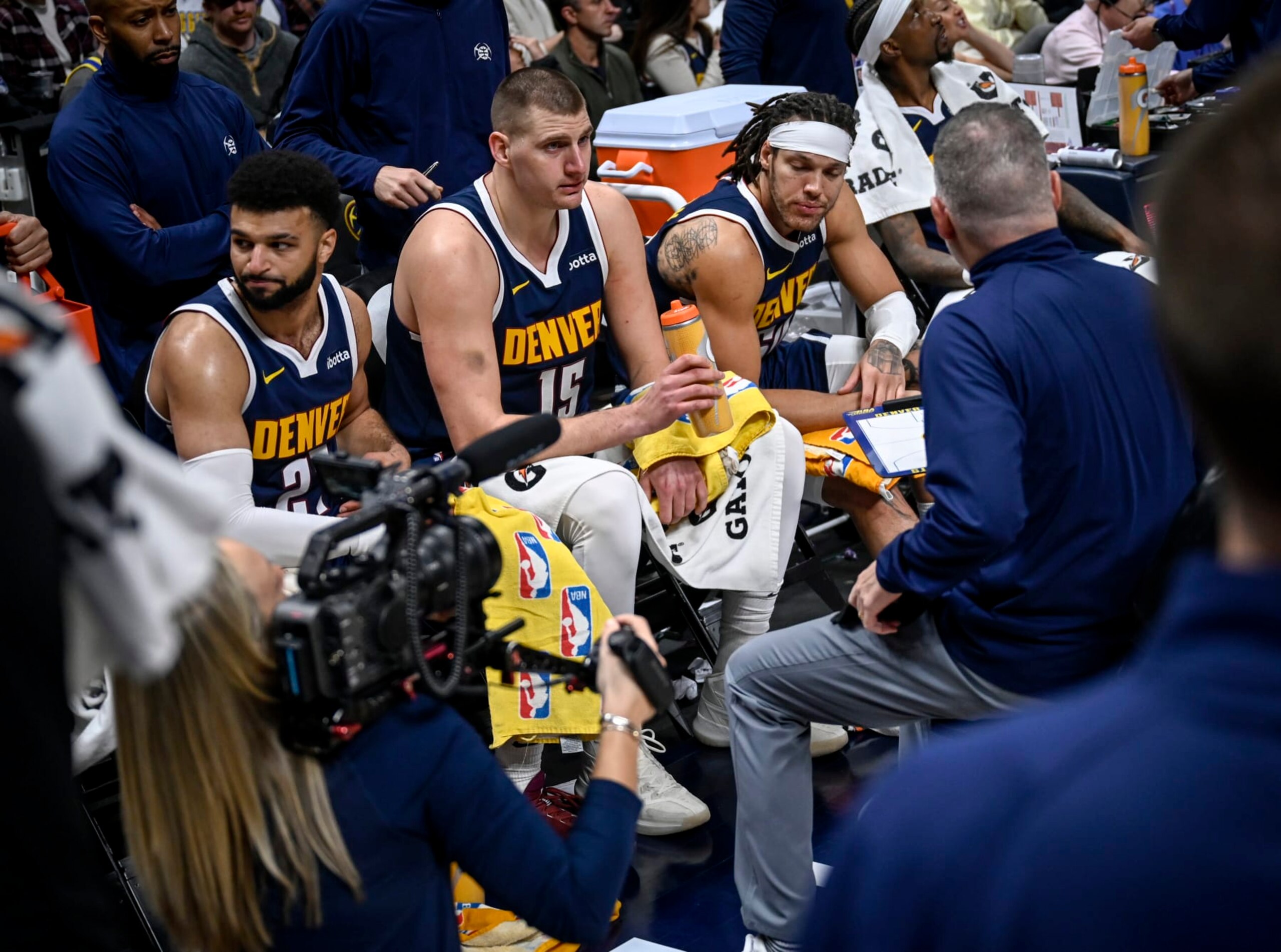 DENVER, CO - JANUARY 14: Jamal Murray (27), Nikola Jokic (15), Aaron Gordon (50) and Kentavious Caldwell-Pope (5) of the Denver Nuggets sit on the bench for a timeout as head coach Michael Malone speaks during the second quarter at Ball Arena in Denver on Sunday, January 14, 2024. (Photo by AAron Ontiveroz/The Denver Post)