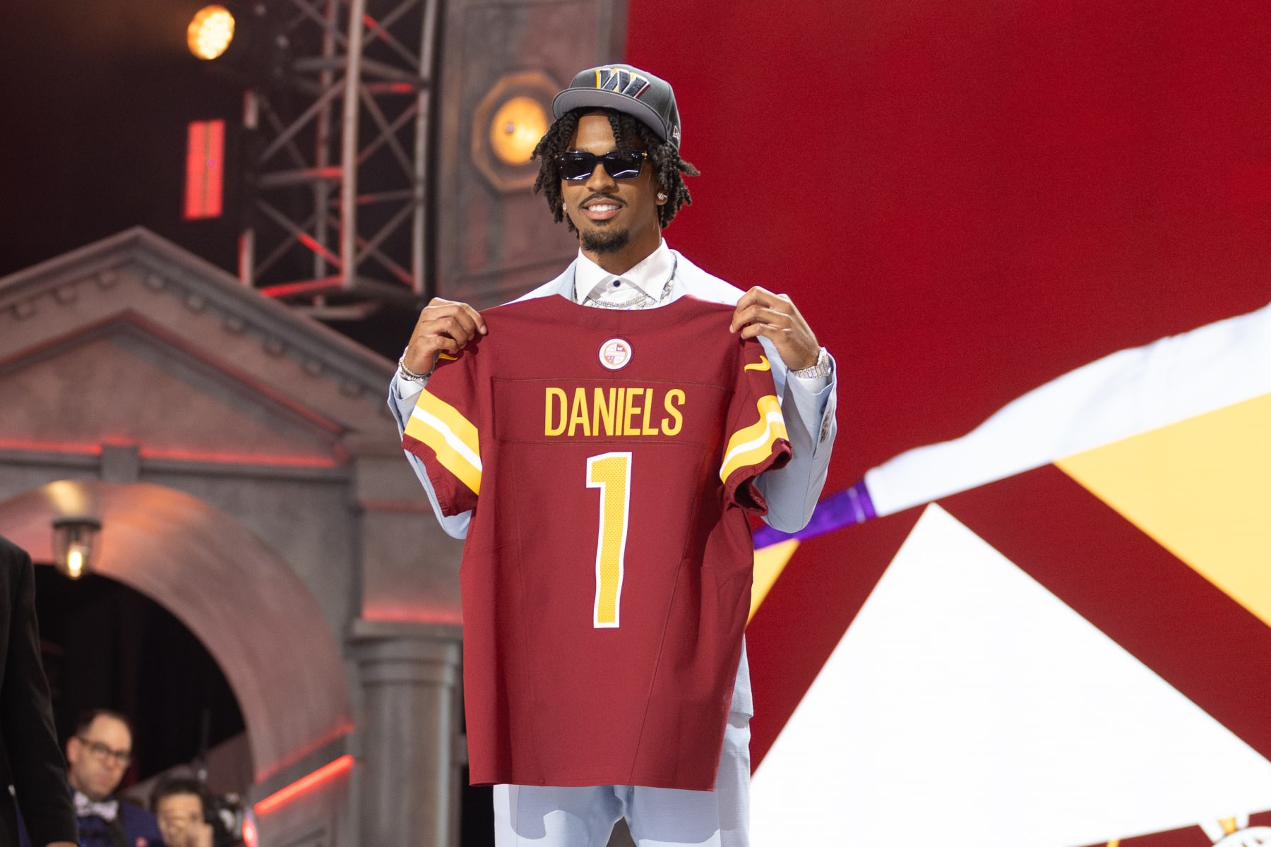 DETROIT, MI - APRIL 25: Washington Commanders Quarterback Jayden Daniels poses with a jersey after being picked second overall during day 1 of the NFL Draft on April 25, 2024 at Fox Theatre in Detroit, MI. (Photo by John Smolek/Icon Sportswire via Getty Images)