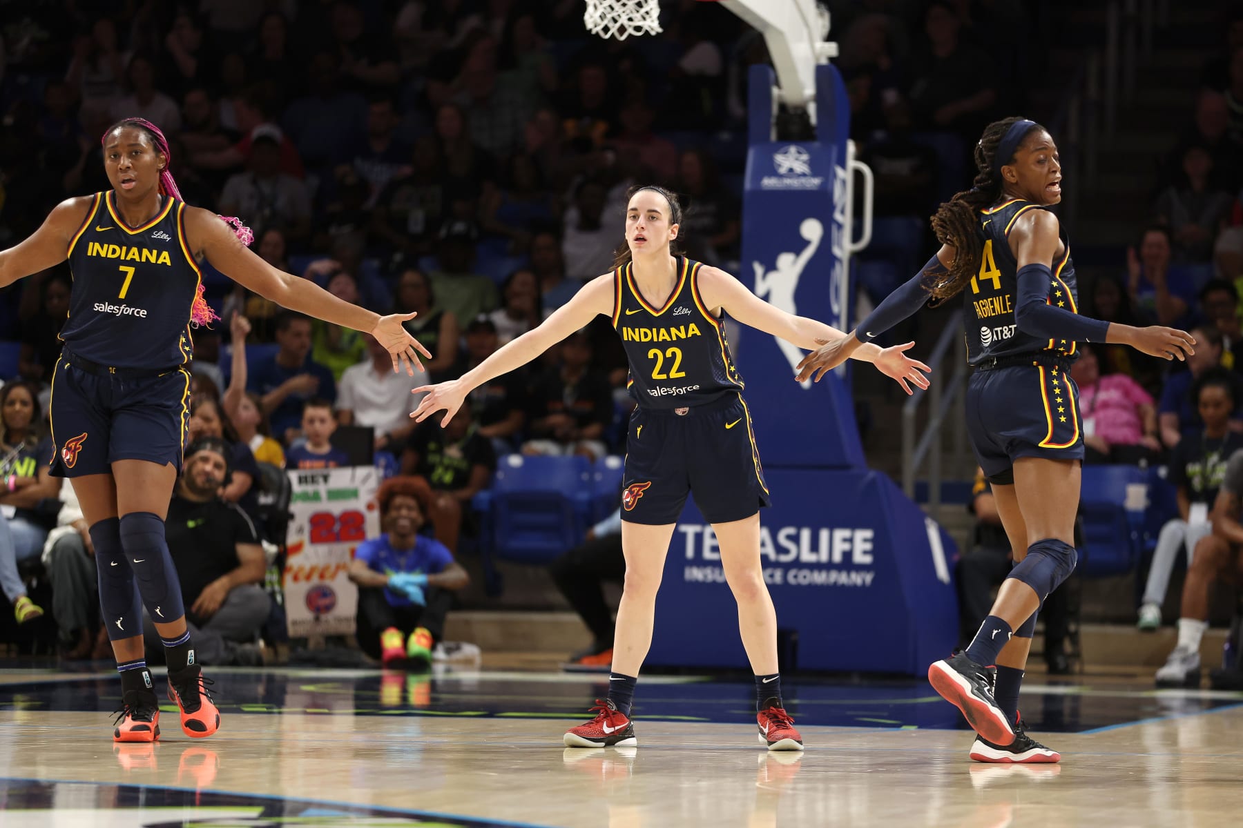 ARLINGTON, TEXAS - MAY 03: Caitlin Clark #22 of the Indiana Fever celebrates a first half three pointer with Allya Boston #7 and Tami Fagbenle #14 while playing the Dallas Wings at College Park Center on May 03, 2024 in Arlington, Texas.  (Photo by Gregory Shamus/Getty Images)