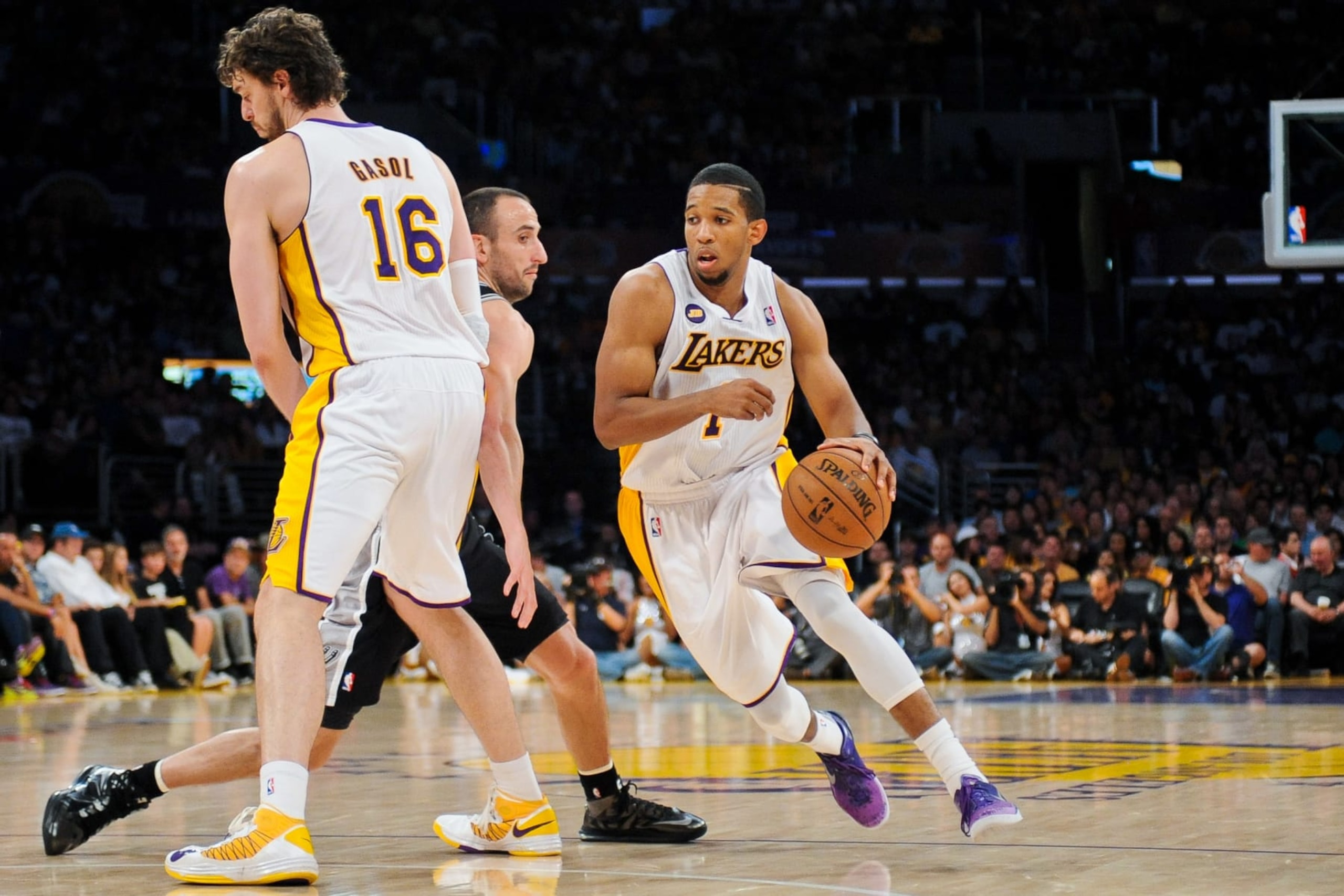 LOS ANGELES, CA - APRIL 28: Darius Morris #1 of the Los Angeles Lakers drives off a screen by teammate Pau Gasol #16 against Manu Ginobili #20 of the San Antonio Spurs in Game Four of the Western Conference Quarterfinals during the 2013 NBA Playoffs at Staples Center on April 28, 2013 in Los Angeles, California. NOTE TO USER: User expressly acknowledges and agrees that, by downloading and/or using this Photograph, user is consenting to the terms and conditions of the Getty Images License Agreement. Mandatory Copyright Notice: Copyright 2013 NBAE (Photo by Noah Graham/NBAE via Getty Images)