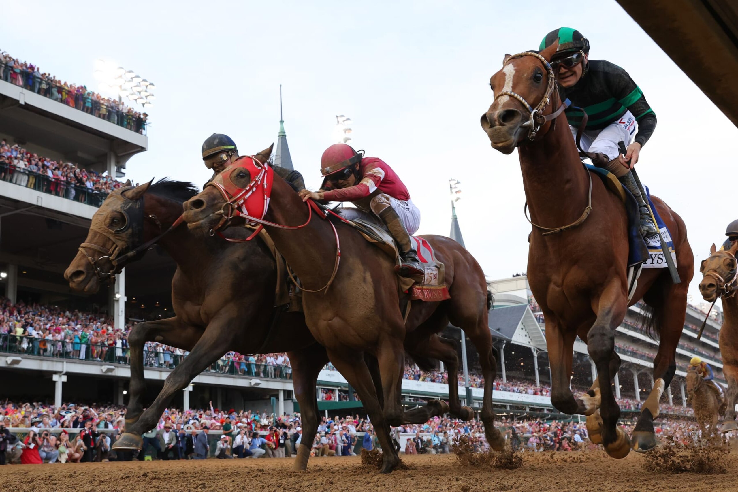 LOUISVILLE, KENTUCKY - MAY 04: Mystik Dan #3, ridden by jockey Brian J. Hernandez Jr. (R), crosses the finish line ahead of Sierra Leone #2, ridden by jockey Tyler Gaffalione and Forever Young, ridden by jockey Ryusei Sakai to win the 150th running of the Kentucky Derby at Churchill Downs on May 04, 2024 in Louisville, Kentucky. (Photo by Michael Reaves/Getty Images)