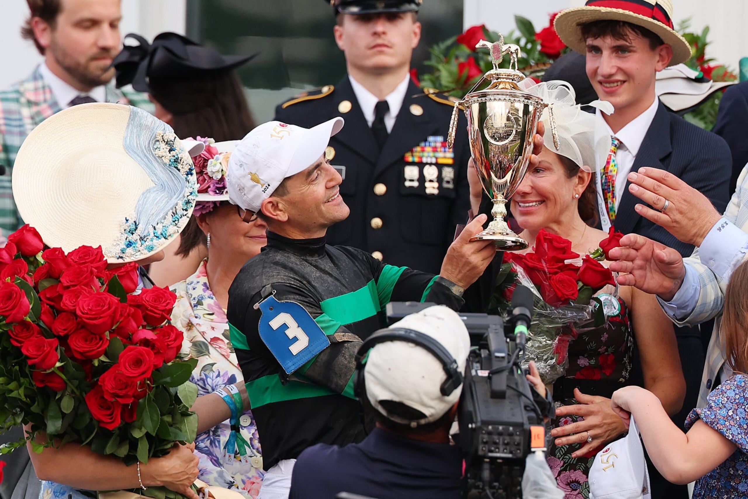 Jockey Brian Hernandez Jr. celebrates with the trophy after winning the 150th running of the Kentucky Derby at Churchill Downs