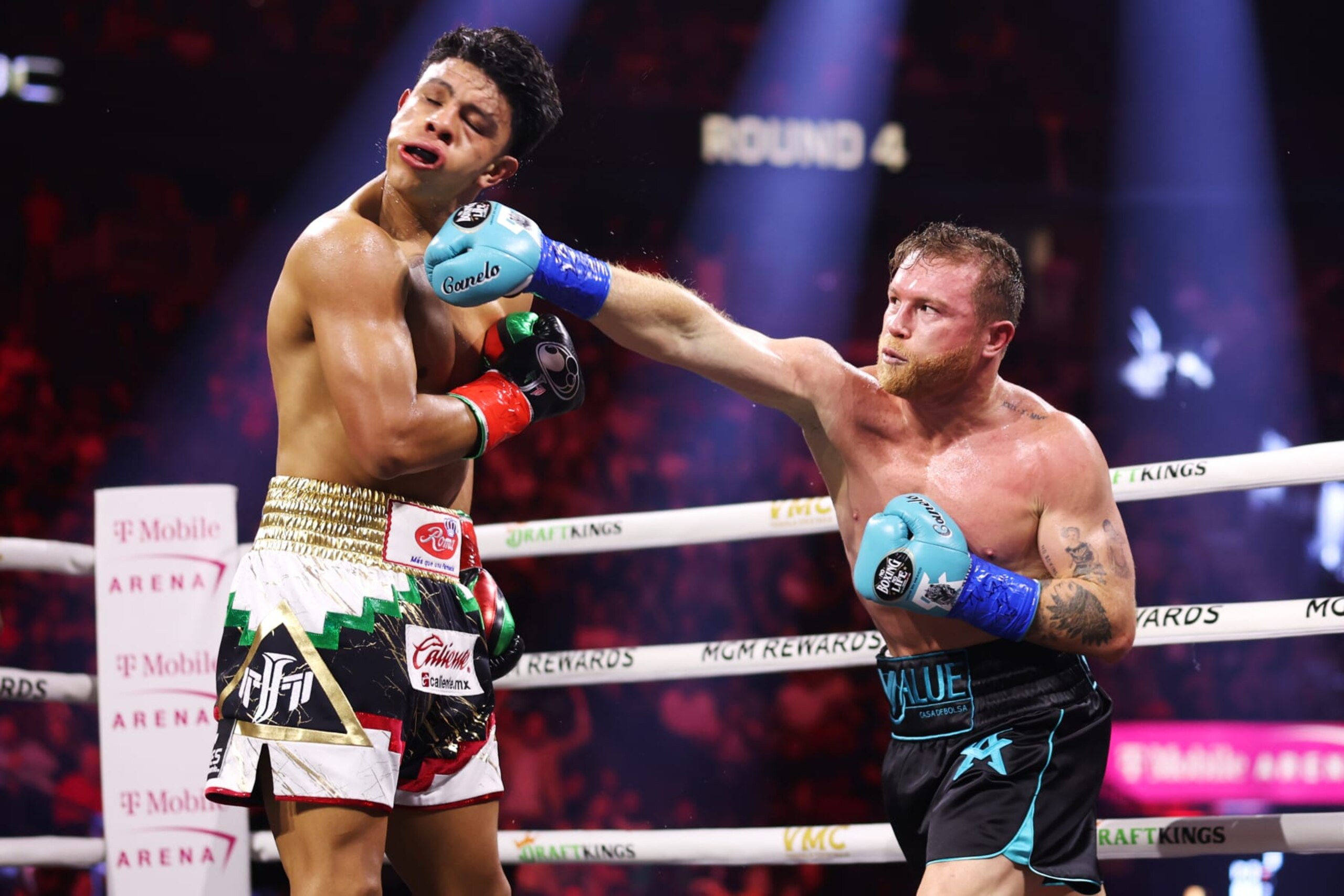 LAS VEGAS, NEVADA - MAY 04: Canelo Alvarez of Mexico (R) lands a punch on Jaime Munguia (L) during their super middleweight title fight at T-Mobile Arena on May 04, 2024 in Las Vegas, Nevada. (Photo by Cris Esqueda/Golden Boy/Getty Images)