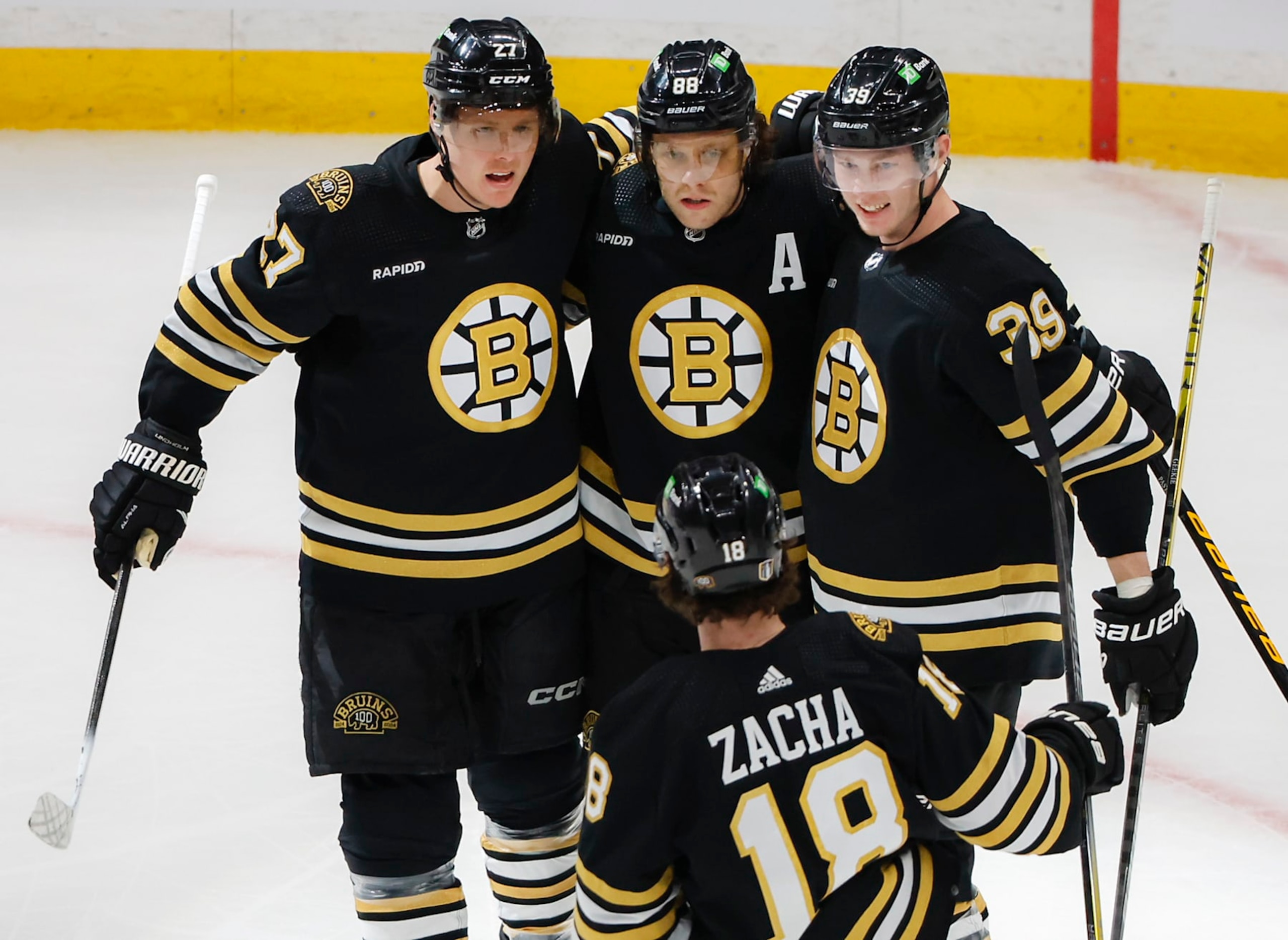 Boston, MA - April 22: Boston Bruins right wing David Pastrnak celebrates his goal with teammates Hampus Lindholm, Morgan Geekie, and Pavel Zacha in the first period. (Photo by Matthew J. Lee/The Boston Globe via Getty Images)
