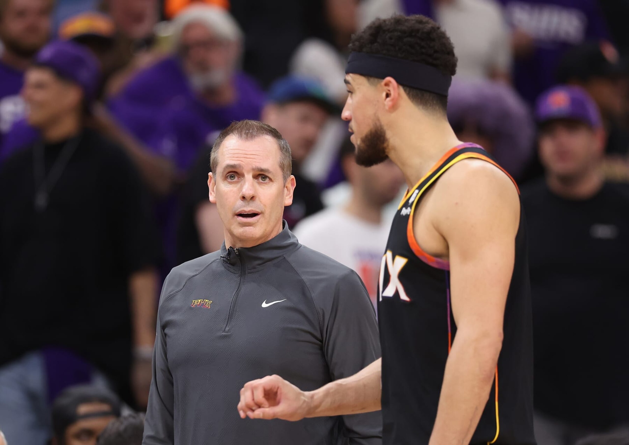 PHOENIX, ARIZONA - APRIL 28: Head coach Frank Vogel of the Phoenix Suns talks with Devin Booker #1 during the second half of game four of the Western Conference First Round Playoffs at Footprint Center on April 28, 2024 in Phoenix, Arizona. The Timberwolves defeated the Suns 122-116 and win the series 4-0.  NOTE TO USER: User expressly acknowledges and agrees that, by downloading and or using this photograph, User is consenting to the terms and conditions of the Getty Images License Agreement.  (Photo by Christian Petersen/Getty Images)