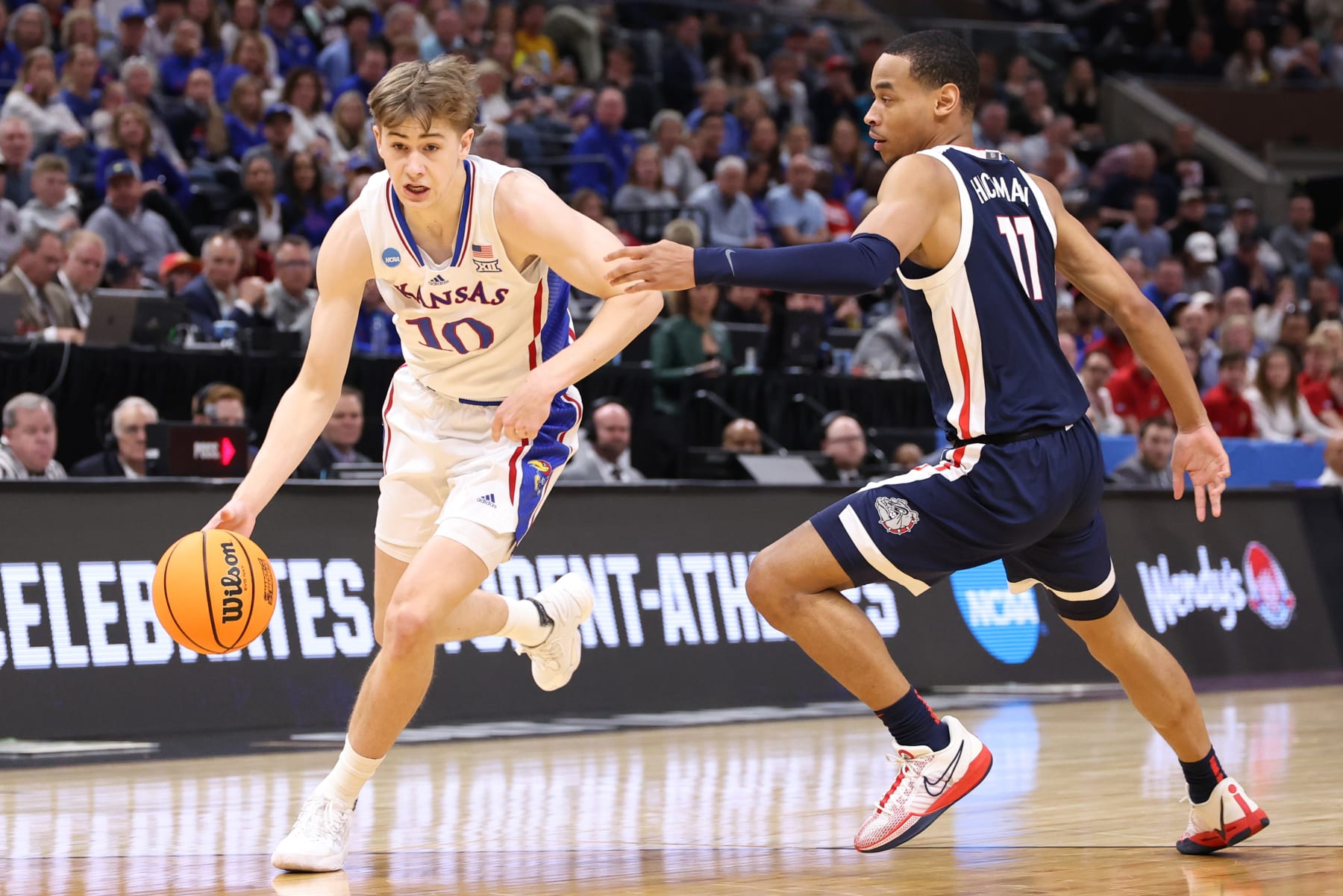 SALT LAKE CITY, UTAH - MARCH 23: Johnny Furphy #10 of the Kansas Jayhawks dribbles against Nolan Hickman #11 of the Gonzaga Bulldogs during the first half in the second round of the NCAA Men's Basketball Tournament at Delta Center on March 23, 2024 in Salt Lake City, Utah. (Photo by Christian Petersen/Getty Images)