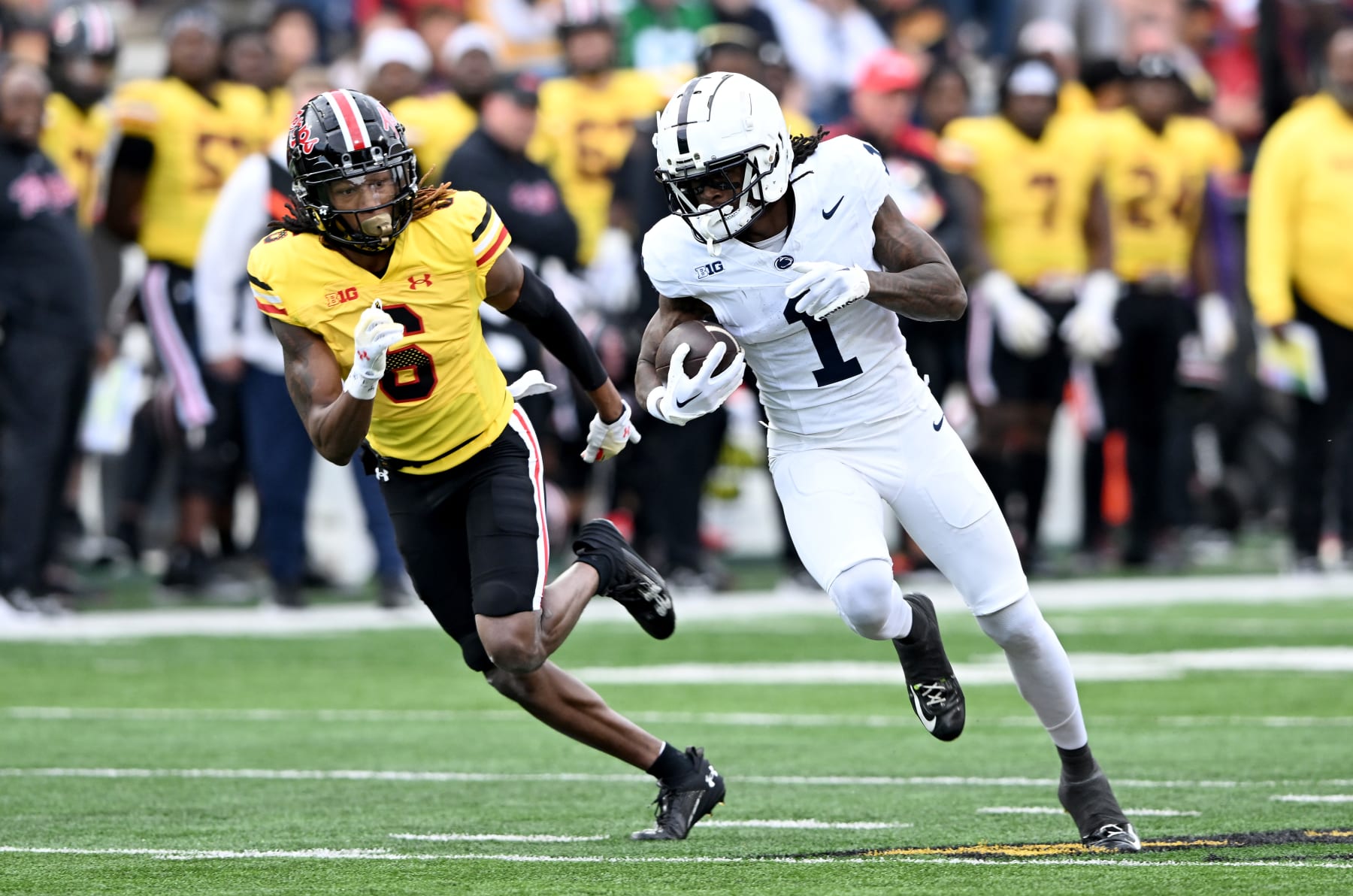 COLLEGE PARK, MARYLAND - NOVEMBER 04: KeAndre Lambert-Smith #1 of the Penn State Nittany Lions runs with the ball after a catch against Corey Coley Jr. #6 of the Maryland Terrapins at SECU Stadium on November 04, 2023 in College Park, Maryland. (Photo by G Fiume/Getty Images)