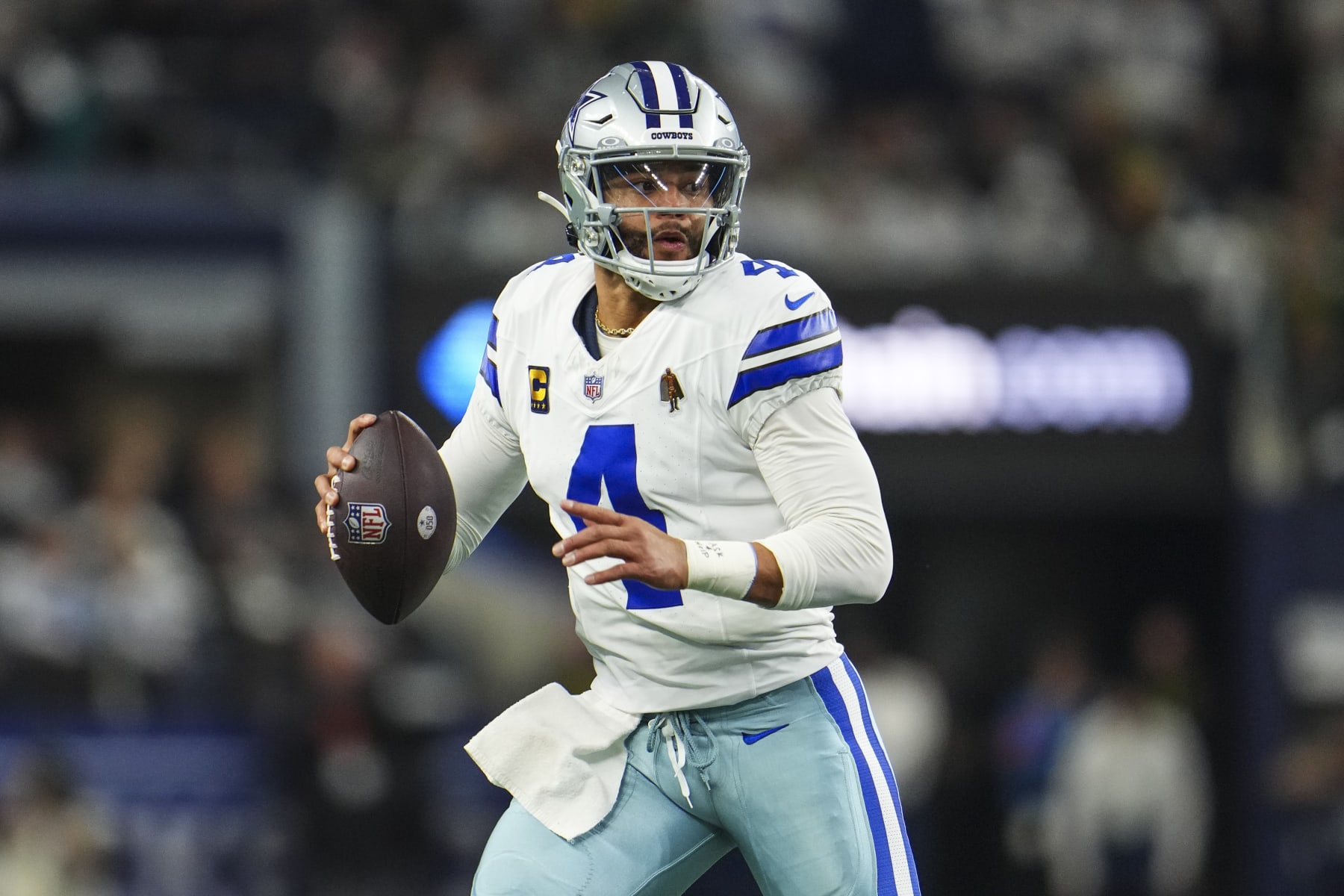 DALLAS, TX - JANUARY 14: Dak Prescott #4 of the Dallas Cowboys scrambles out of the pocket during an NFL wild-card playoff football game against the Green Bay Packers at AT&T Stadium on January 14, 2024 in Dallas, Texas. (Photo by Cooper Neill/Getty Images)