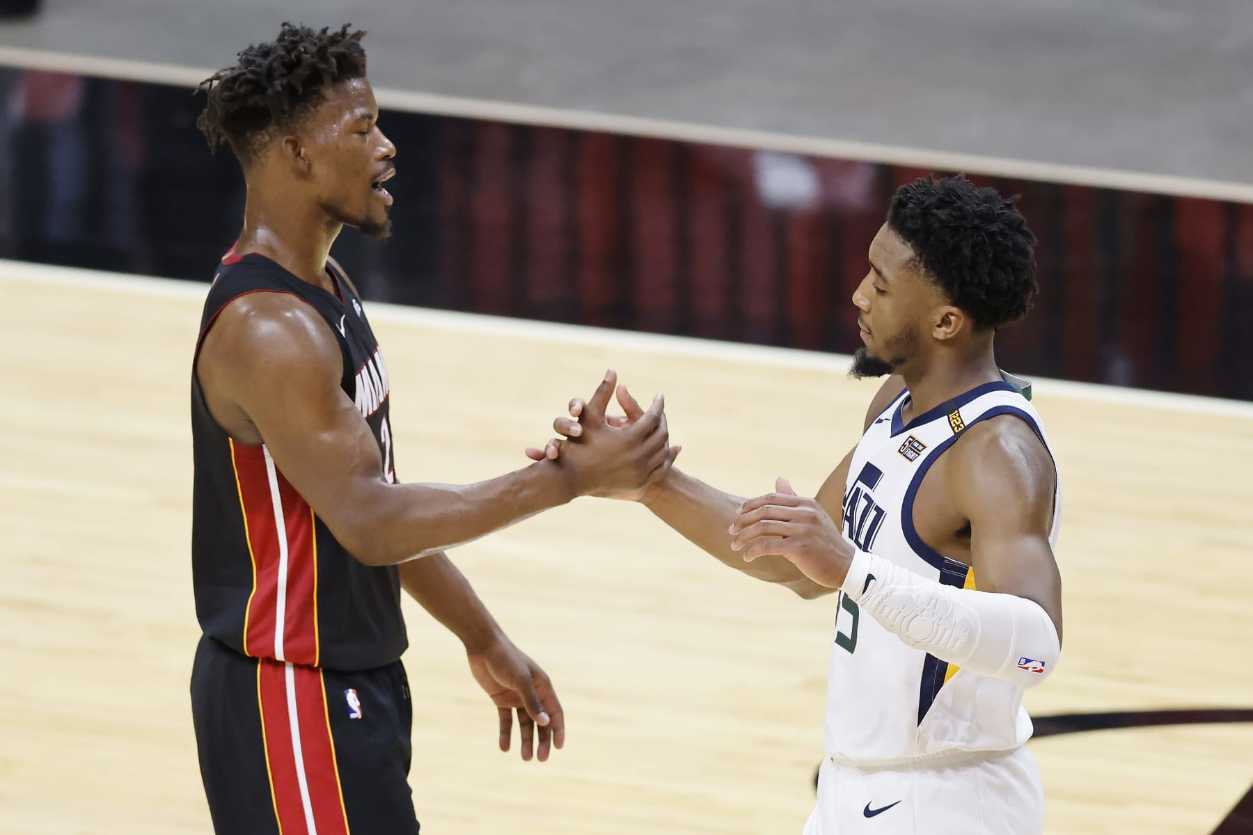 MIAMI, FLORIDA - FEBRUARY 26: Jimmy Butler #22 of the Miami Heat greets Donovan Mitchell #45 of the Utah Jazz after the game at American Airlines Arena on February 26, 2021 in Miami, Florida. NOTE TO USER: User expressly acknowledges and agrees that, by downloading and or using this photograph, User is consenting to the terms and conditions of the Getty Images License Agreement.  (Photo by Michael Reaves/Getty Images)