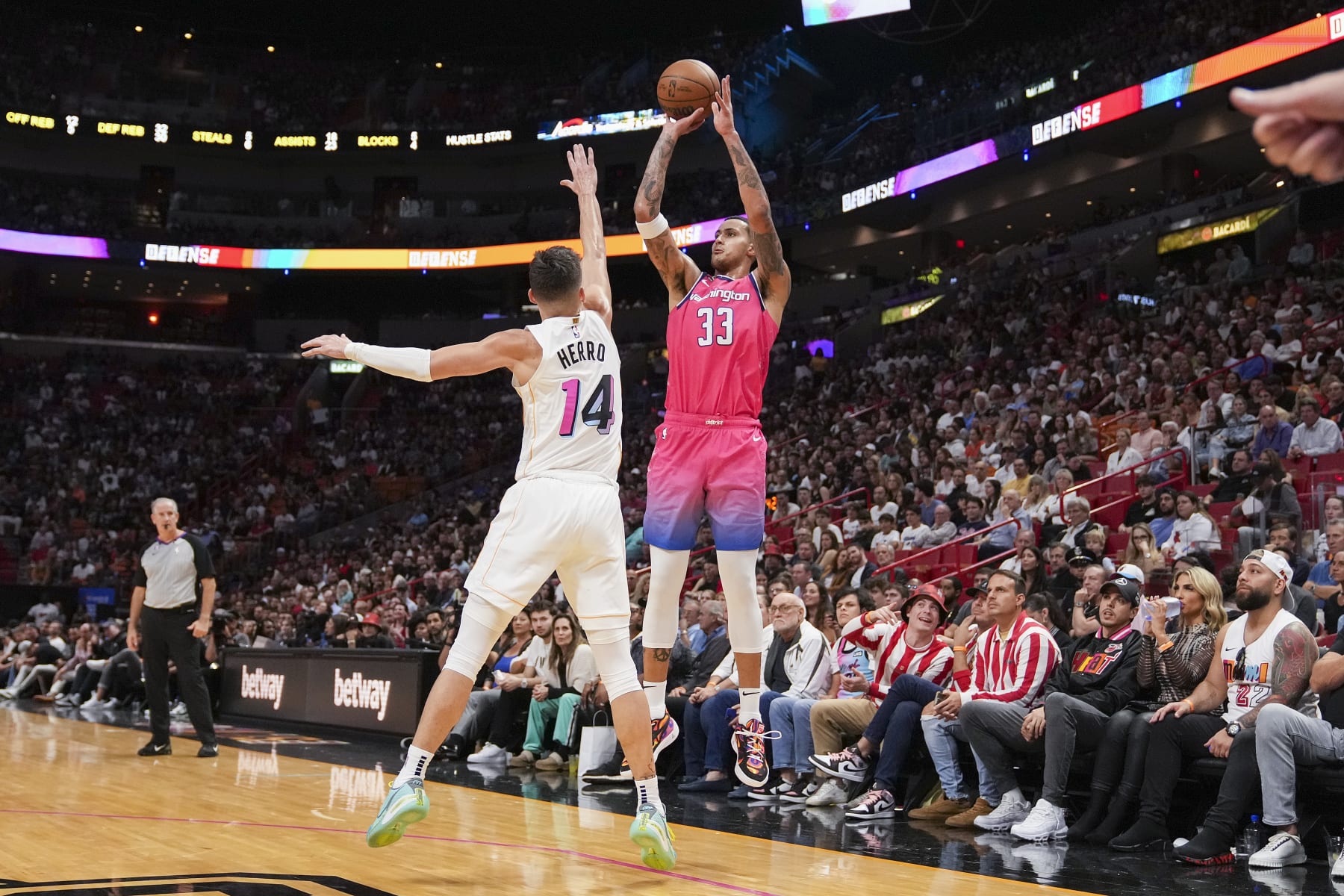 MIAMI, FLORIDA - NOVEMBER 23: Kyle Kuzma #33 of the Washington Wizards attempts a shot while being defended by Tyler Herro #14 of the Miami Heat during the second half against the Miami Heat at FTX Arena on November 23, 2022 in Miami, Florida. NOTE TO USER: User expressly acknowledges and agrees that,  by downloading and or using this photograph,  User is consenting to the terms and conditions of the Getty Images License Agreement. (Photo by Eric Espada/Getty Images)