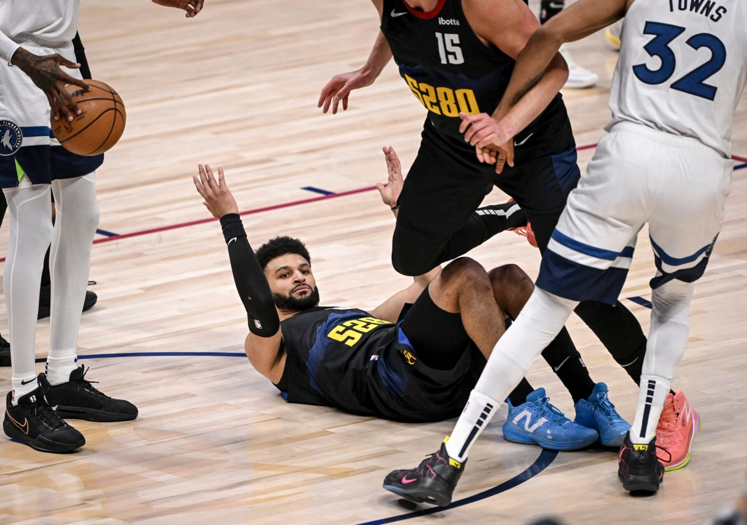 DENVER, CO - MAY 6: Jamal Murray (27) of the Denver Nuggets lies on the floor expecting a charging call against Karl-Anthony Towns (32) of the Minnesota Timberwolves during the first quarter at Ball Arena in Denver on Monday, May 6, 2024. The call would not come resulting in an eruption by Nuggets head coach Michael Malone. (Photo by AAron Ontiveroz/The Denver Post) DENVER, CO - MAY 6: Jamal Murray (27) of the Denver Nuggets lies on the floor expecting a charging call against Karl-Anthony Towns (32) of the Minnesota Timberwolves during the first quarter at Ball Arena in Denver on Monday, May 6, 2024. The call would not come resulting in an eruption by Nuggets head coach Michael Malone. (Photo by AAron Ontiveroz/The Denver Post)