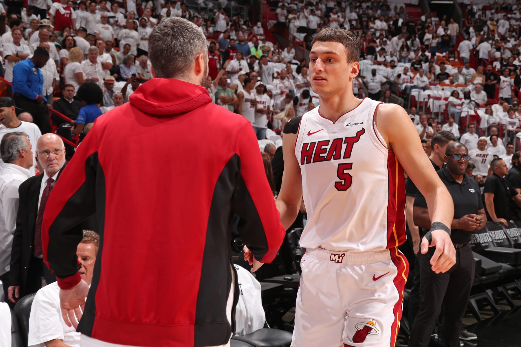 MIAMI, FL - APRIL 29: Nikola Jovic #5 and Kevin Love #42 of the Miami Heat embrace before the game against the Boston Celtics during Round 1 Game 4 of the 2024 NBA Playoffs on April 29, 2024 at Kaseya Center in Miami, Florida. NOTE TO USER: User expressly acknowledges and agrees that, by downloading and or using this Photograph, user is consenting to the terms and conditions of the Getty Images License Agreement. Mandatory Copyright Notice: Copyright 2024 NBAE (Photo by Issac Baldizon/NBAE via Getty Images)