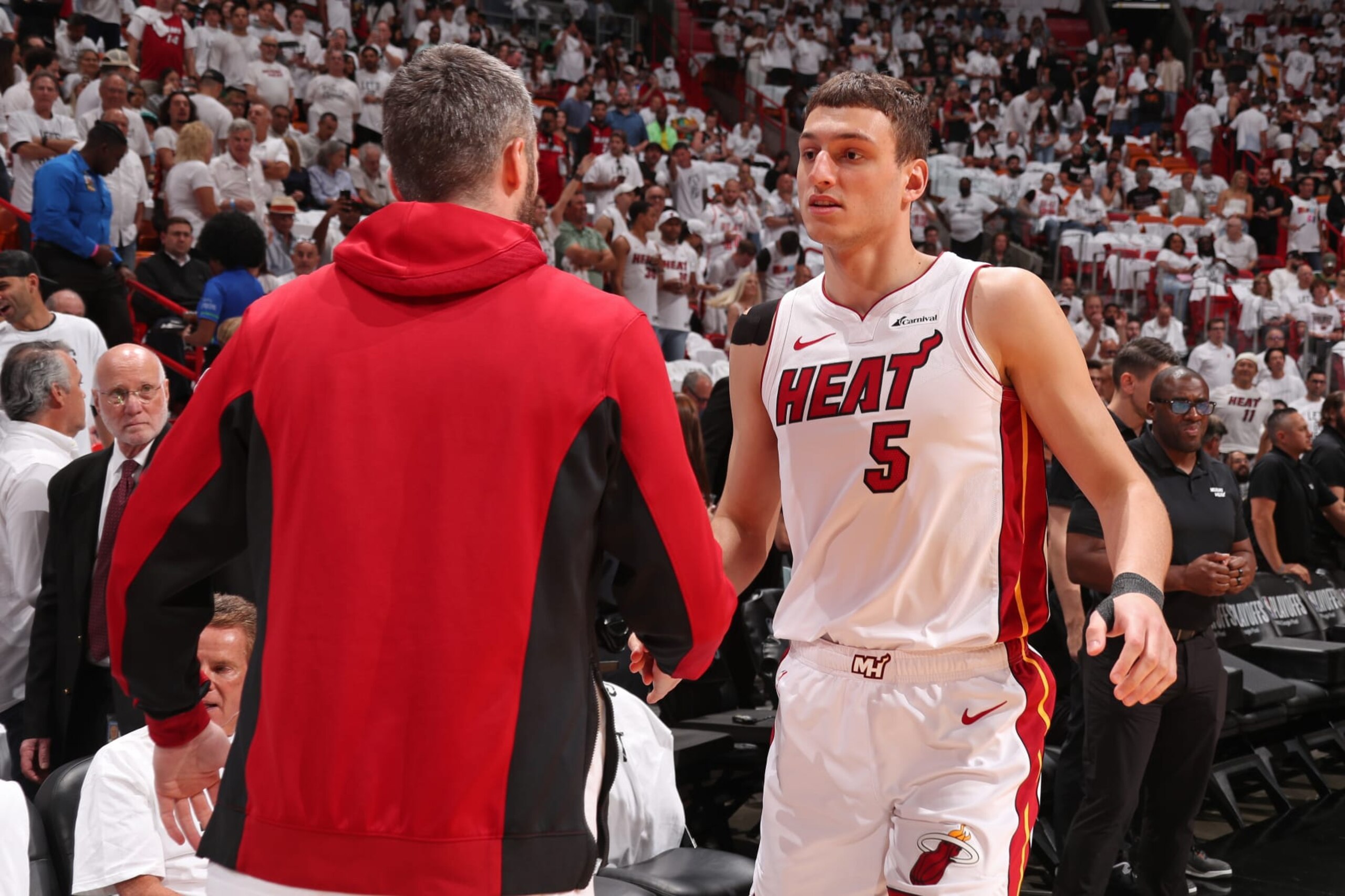 MIAMI, FL - APRIL 29: Nikola Jovic #5 and Kevin Love #42 of the Miami Heat embrace before the game against the Boston Celtics during Round 1 Game 4 of the 2024 NBA Playoffs on April 29, 2024 at Kaseya Center in Miami, Florida. NOTE TO USER: User expressly acknowledges and agrees that, by downloading and or using this Photograph, user is consenting to the terms and conditions of the Getty Images License Agreement. Mandatory Copyright Notice: Copyright 2024 NBAE (Photo by Issac Baldizon/NBAE via Getty Images) MIAMI, FL - APRIL 29: Nikola Jovic #5 and Kevin Love #42 of the Miami Heat embrace before the game against the Boston Celtics during Round 1 Game 4 of the 2024 NBA Playoffs on April 29, 2024 at Kaseya Center in Miami, Florida. NOTE TO USER: User expressly acknowledges and agrees that, by downloading and or using this Photograph, user is consenting to the terms and conditions of the Getty Images License Agreement. Mandatory Copyright Notice: Copyright 2024 NBAE (Photo by Issac Baldizon/NBAE via Getty Images)