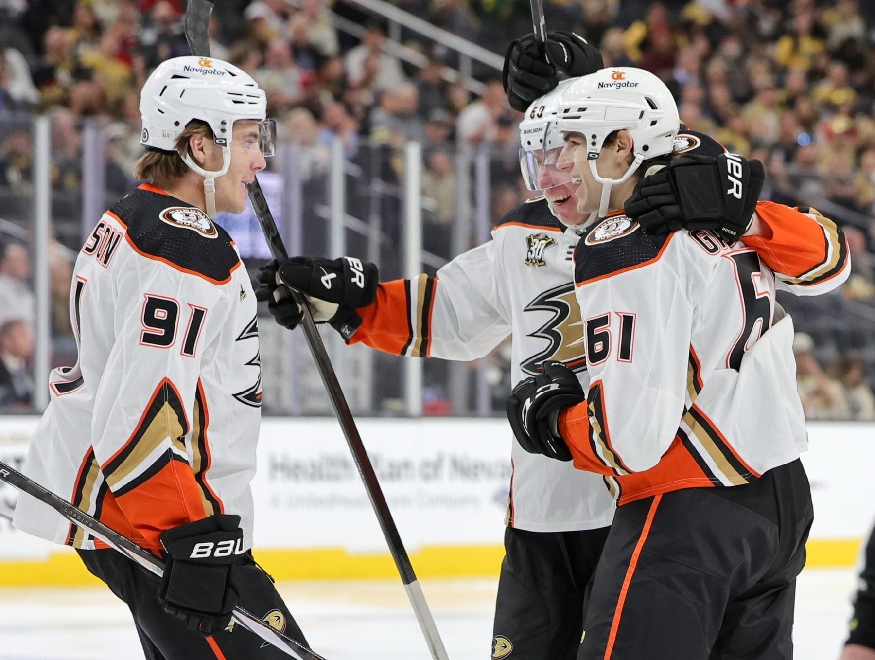 LAS VEGAS, NEVADA - APRIL 18: Leo Carlsson #91, Jackson LaCombe #60 and Cutter Gauthier #61 of the Anaheim Ducks celebrate after Gauthier, playing in his first career NHL game, recorded his first point with an assist on a third-period goal by LaCombe against the Vegas Golden Knights during their game at T-Mobile Arena on April 18, 2024 in Las Vegas, Nevada. The Ducks defeated the Golden Knights 4-1. (Photo by Ethan Miller/Getty Images)