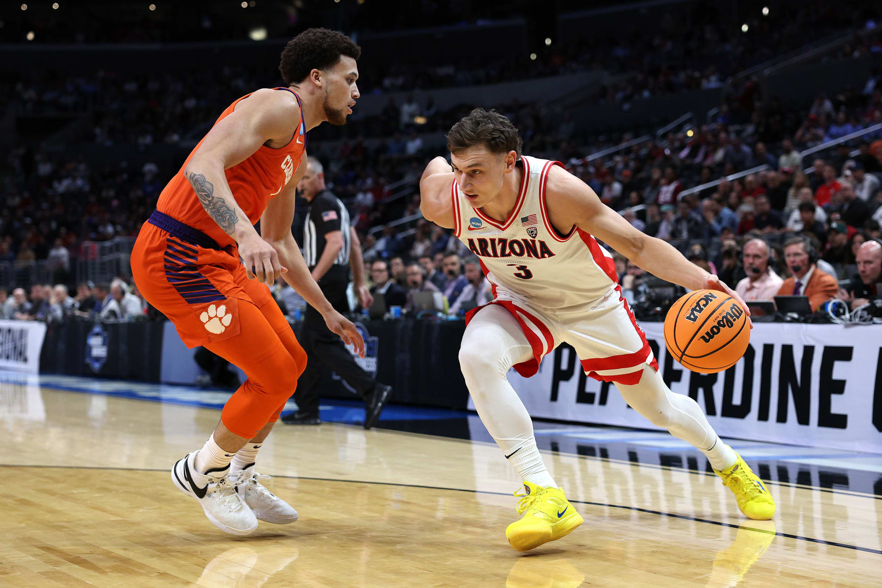 LOS ANGELES, CALIFORNIA - MARCH 28: Pelle Larsson #3 of the Arizona Wildcats drives against Chase Hunter #1 of the Clemson Tigers during the first half in the Sweet 16 round of the NCAA Men's Basketball Tournament at Crypto.com Arena on March 28, 2024 in Los Angeles, California. (Photo by Harry How/Getty Images)