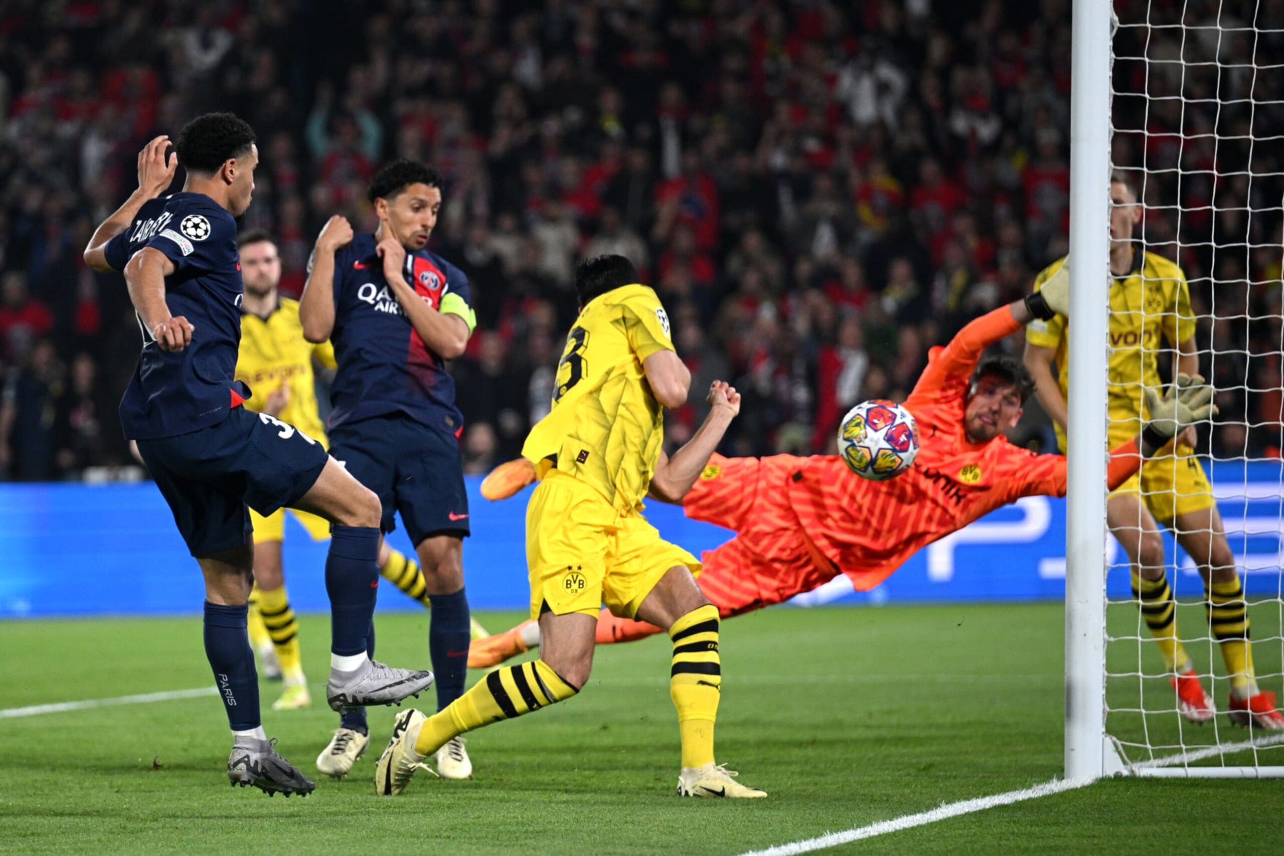 PARIS, FRANCE - MAY 07: Warren Zaire-Emery of Paris Saint-Germain has a shot which hits the post as Gregor Kobel of Borussia Dortmund attempts to  during the UEFA Champions League semi-final second leg match between Paris Saint-Germain and Borussia Dortmund at Parc des Princes on May 07, 2024 in Paris, France.  (Photo by Matthias Hangst/Getty Images)