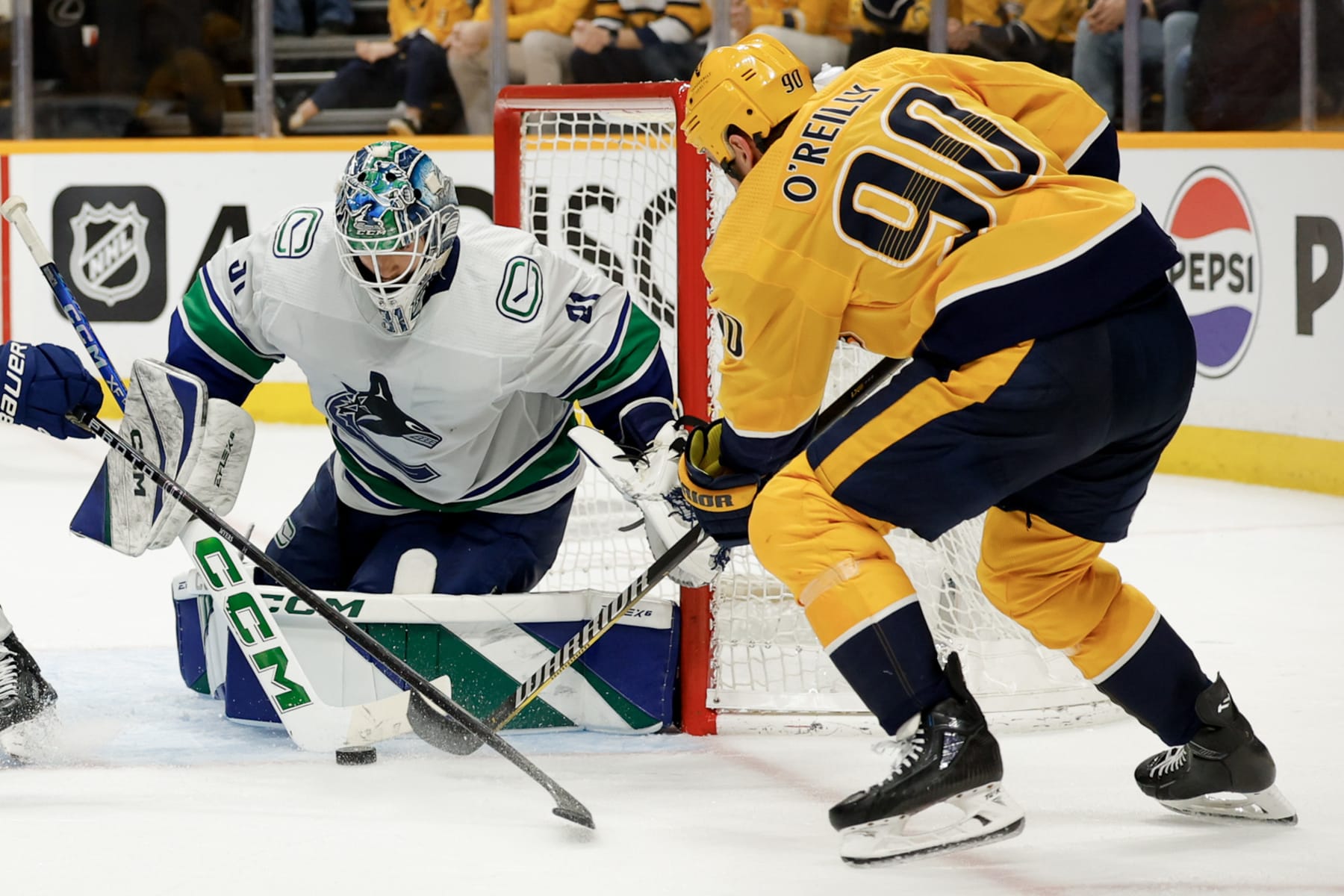NASHVILLE, TENNESSEE - MAY 03: Arturs Silovs #31 of the Vancouver Canucks makes a save against Ryan O'Reilly #90 of the Nashville Predators during the third period in Game Six of the Western Conference First Round Playoffs at Bridgestone Arena on May 03, 2024 in Nashville, Tennessee. (Photo by Brett Carlsen/Getty Images) NASHVILLE, TENNESSEE - MAY 03: Arturs Silovs #31 of the Vancouver Canucks makes a save against Ryan O'Reilly #90 of the Nashville Predators during the third period in Game Six of the Western Conference First Round Playoffs at Bridgestone Arena on May 03, 2024 in Nashville, Tennessee. (Photo by Brett Carlsen/Getty Images)