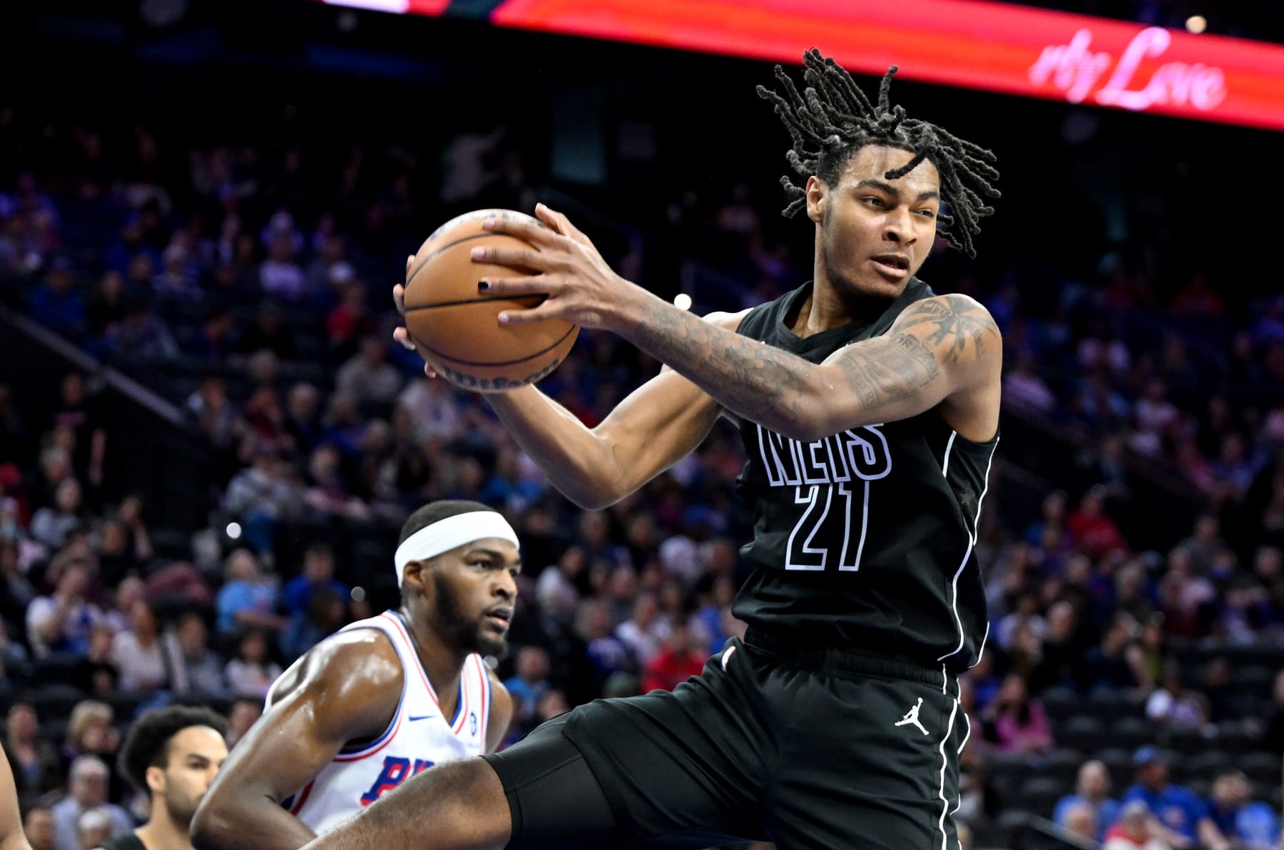 PHILADELPHIA, PENNSYLVANIA - APRIL 14: Noah Clowney #21 of the Brooklyn Nets grabs a rebound against the Philadelphia 76ers at the Wells Fargo Center on April 14, 2024 in Philadelphia, Pennsylvania.  NOTE TO USER: User expressly acknowledges and agrees that, by downloading and or using this photograph, User is consenting to the terms and conditions of the Getty Images License Agreement. (Photo by G Fiume/Getty Images)