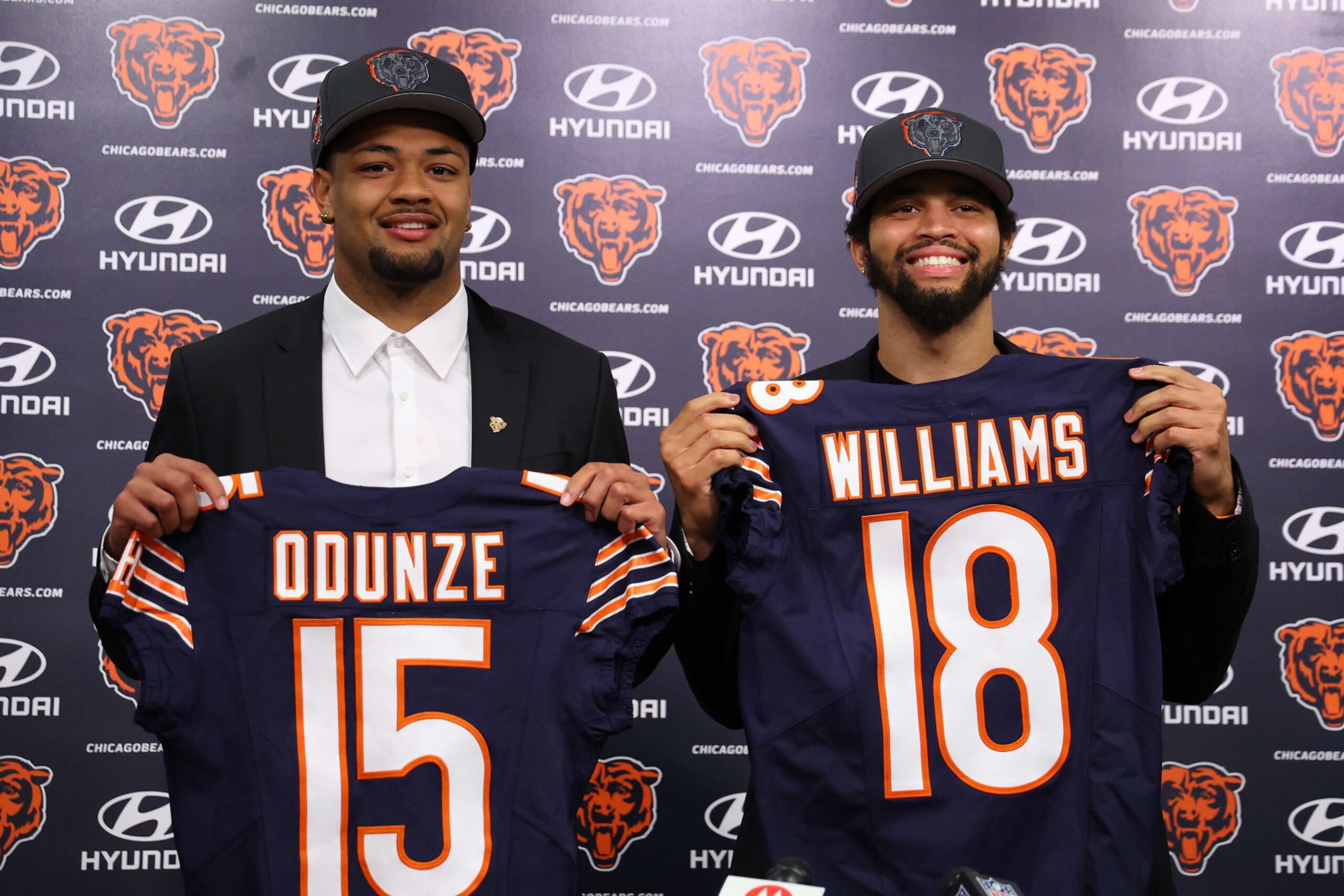 LAKE FOREST, ILLINOIS - APRIL 26: Rome Odunze #15 and Caleb Williams #18 of the Chicago Bears pose for a photo during their introductory press conference at Halas Hall on April 26, 2024 in Lake Forest, Illinois. Caleb Williams was selected first overall and Rome Odunze was selected ninth overall in the first round of the 2024 NFL Draft Thursday. (Photo by Michael Reaves/Getty Images)