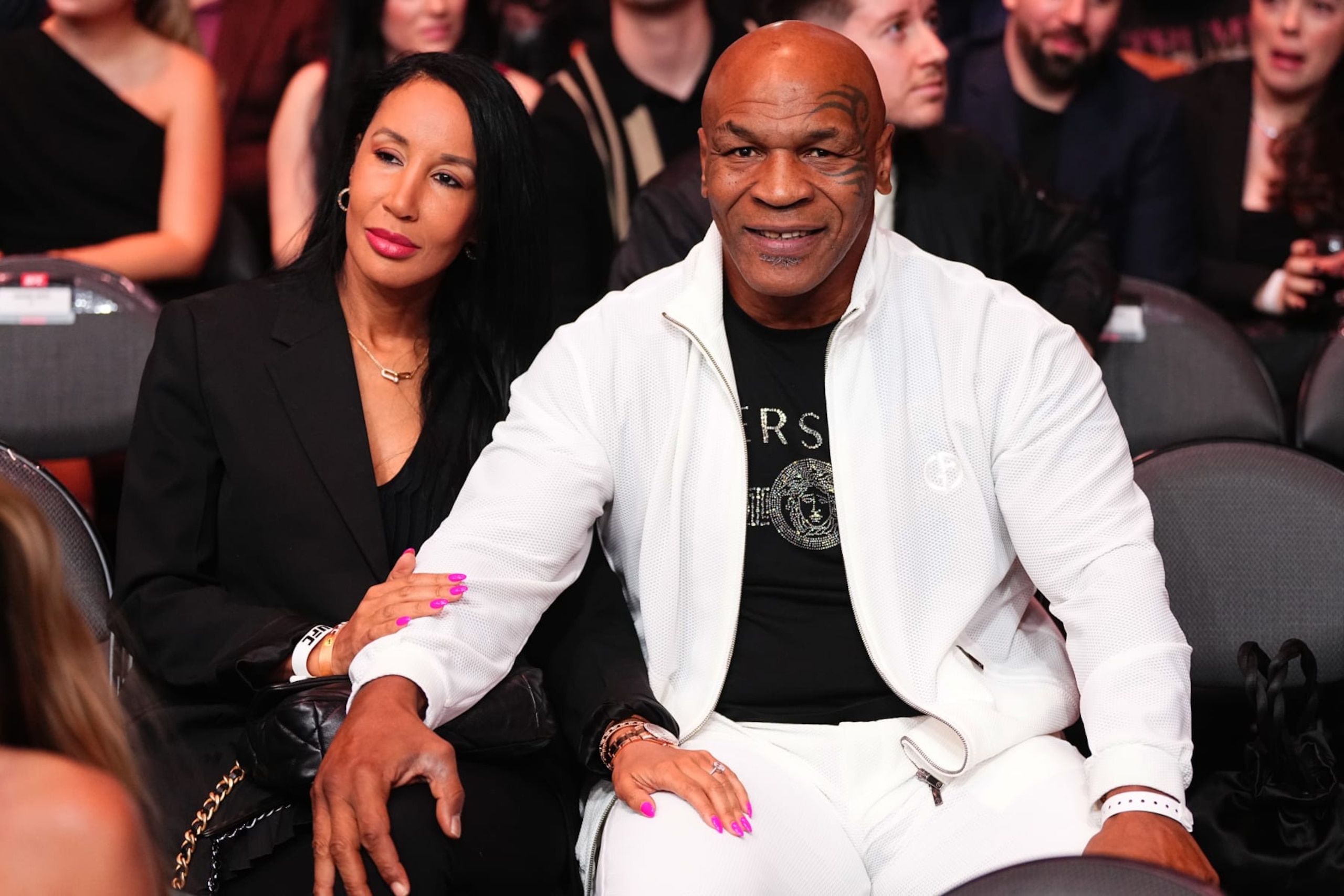 LAS VEGAS, NEVADA - APRIL 13: Mike Tyson and wife attend the UFC 300 event at T-Mobile Arena on April 13, 2024 in Las Vegas, Nevada. (Photo by Jeff Bottari/Zuffa LLC via Getty Images) LAS VEGAS, NEVADA - APRIL 13: Mike Tyson and wife attend the UFC 300 event at T-Mobile Arena on April 13, 2024 in Las Vegas, Nevada. (Photo by Jeff Bottari/Zuffa LLC via Getty Images)