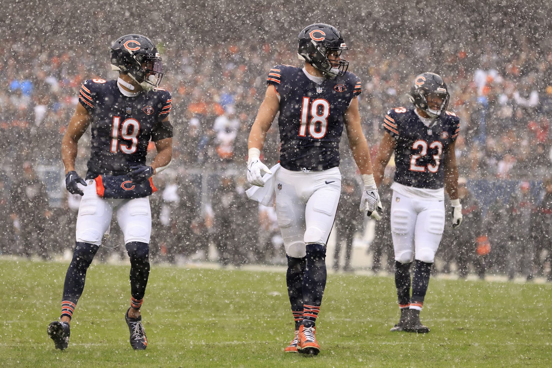CHICAGO, ILLINOIS - DECEMBER 31: Equanimeous St. Brown #19, Robert Tonyan #18 and Roschon Johnson #23 of the Chicago Bears line up in the game against the Atlanta Falcons at Soldier Field on December 31, 2023 in Chicago, Illinois. (Photo by Justin Casterline/Getty Images)